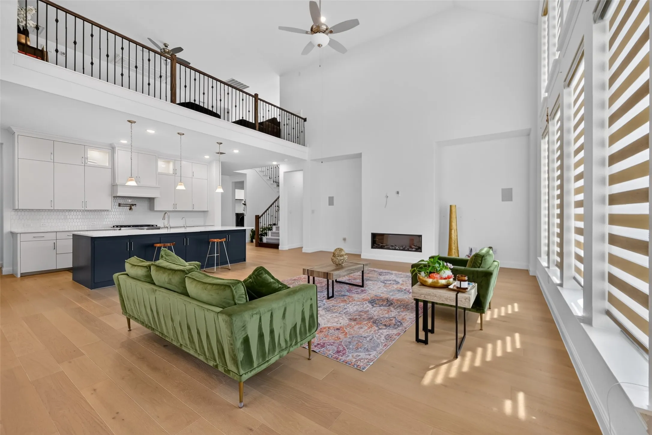 Open-concept living area featuring a vaulted ceiling and wood-finish flooring