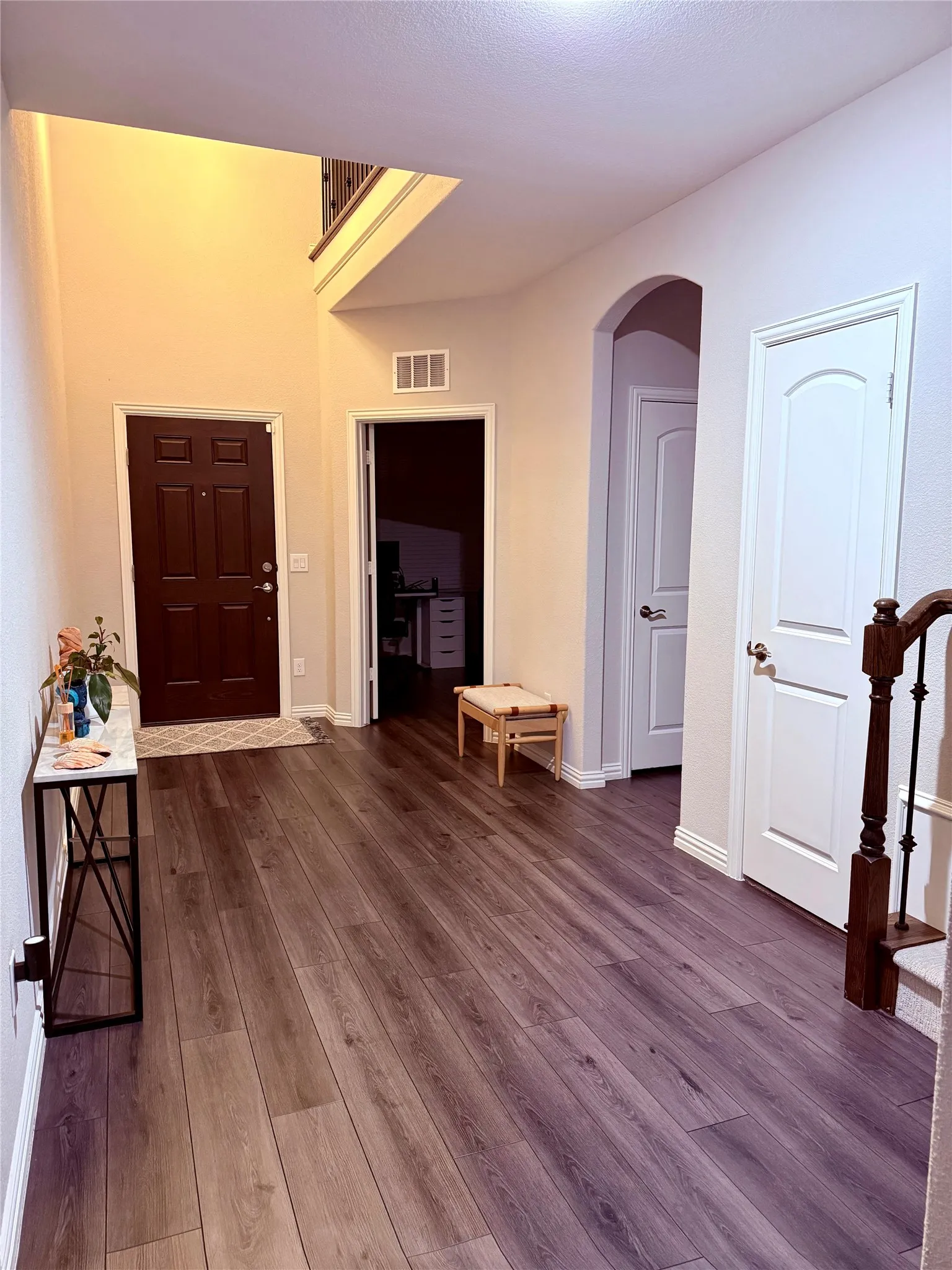 Double-height entry with wood-finish flooring