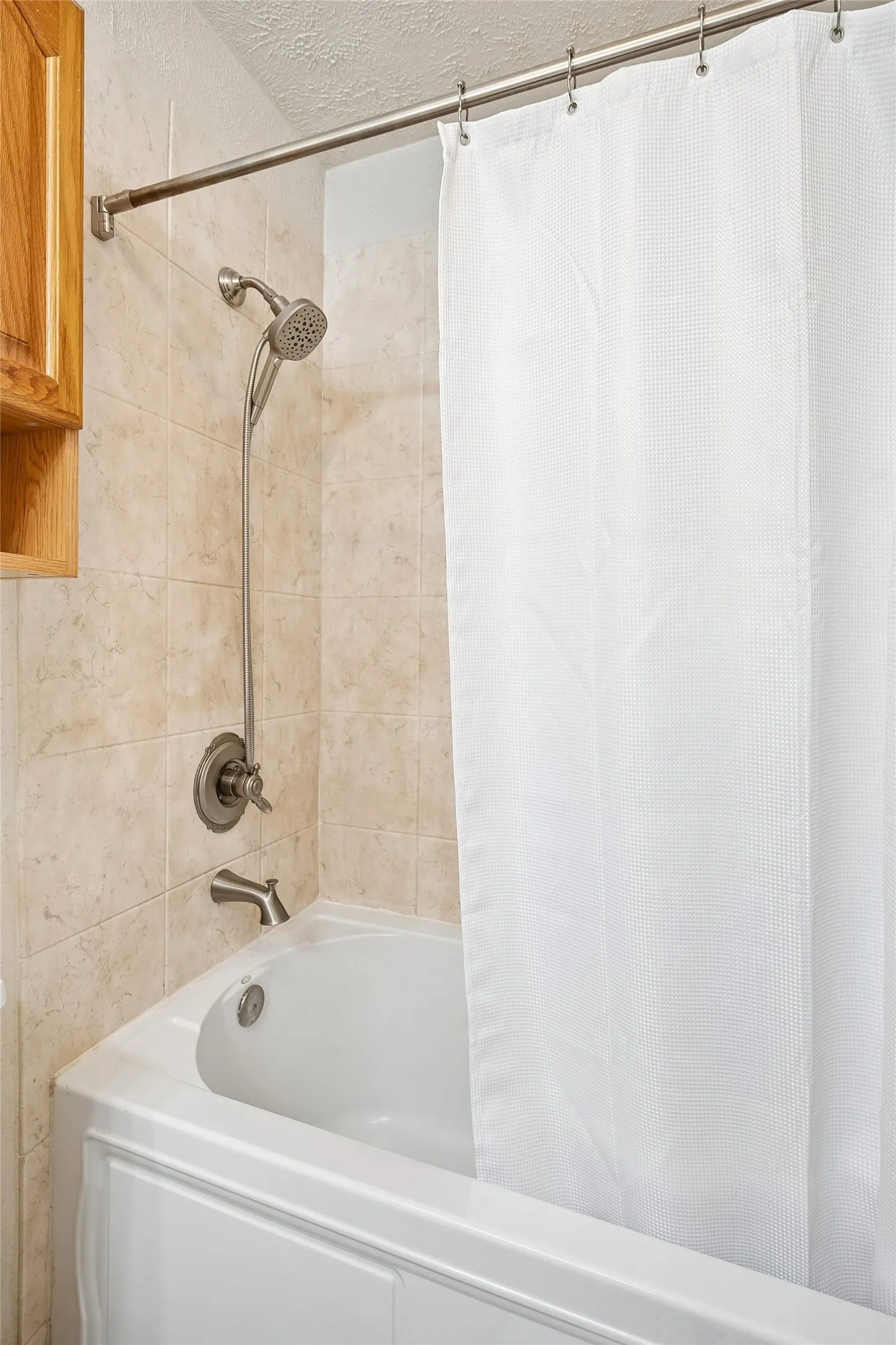 Primary bath with updated tile shower surround.