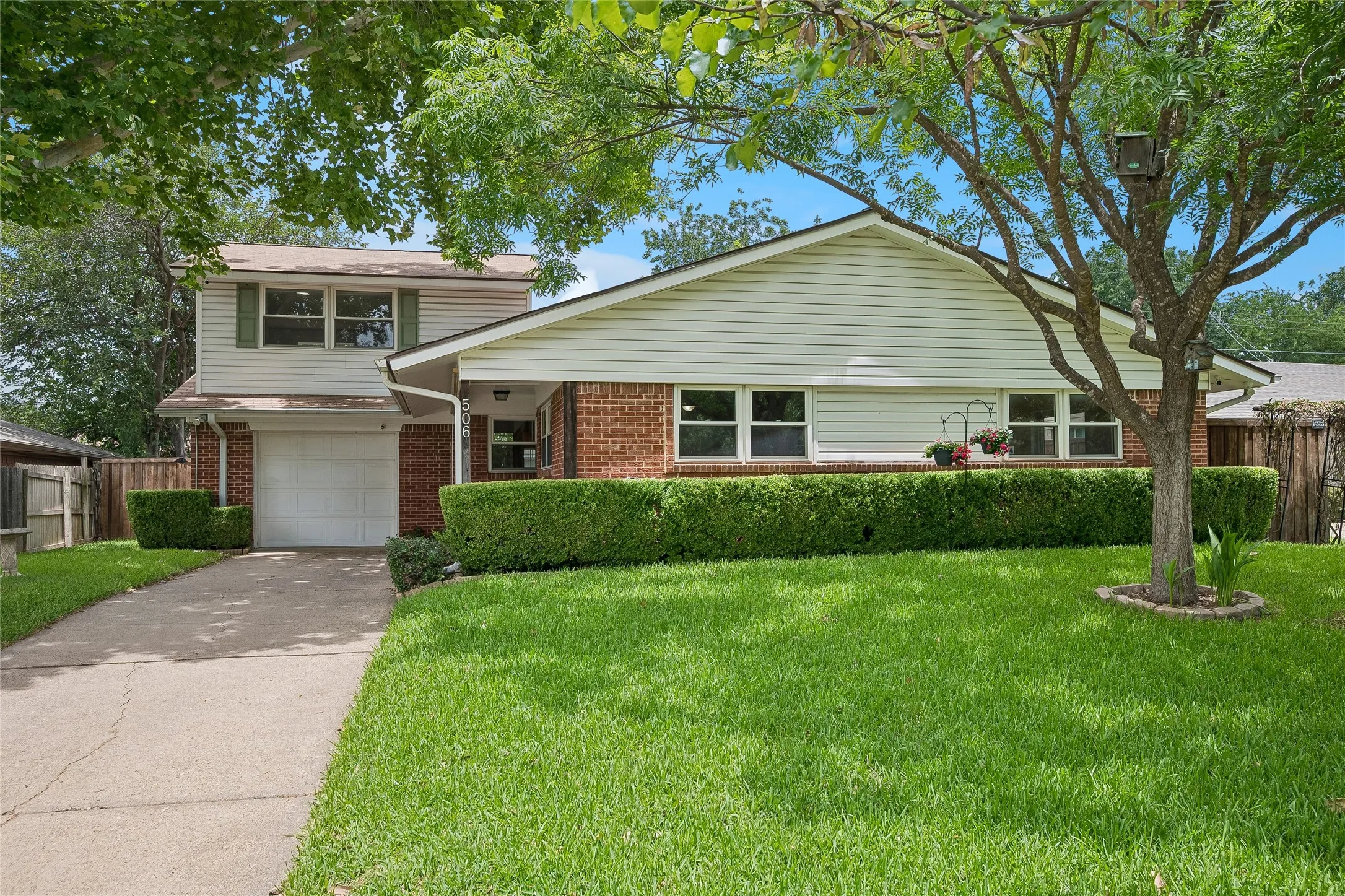 Beautiful red brick charmer with low maintenance vinyl siding, mature shade trees and green lawn with sprinkler system.
