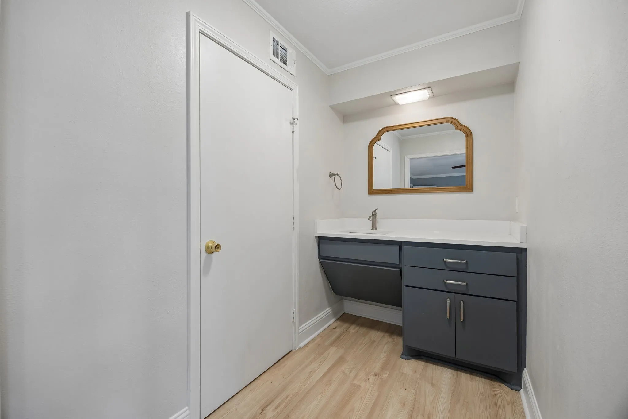 Primary bath with a spacious vanity and a separate shower and toilet area tucked behind the adjoining door.