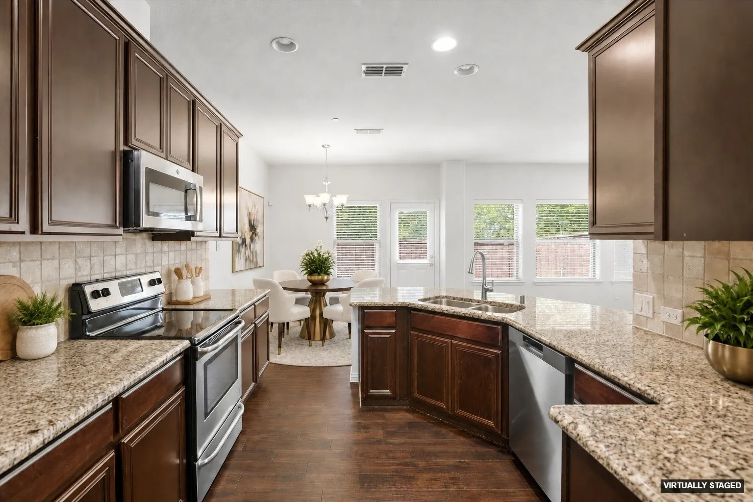 Kitchen view #2 shows up the SS appliances (Viking refrigerator remains! -- Virtually Staged)
