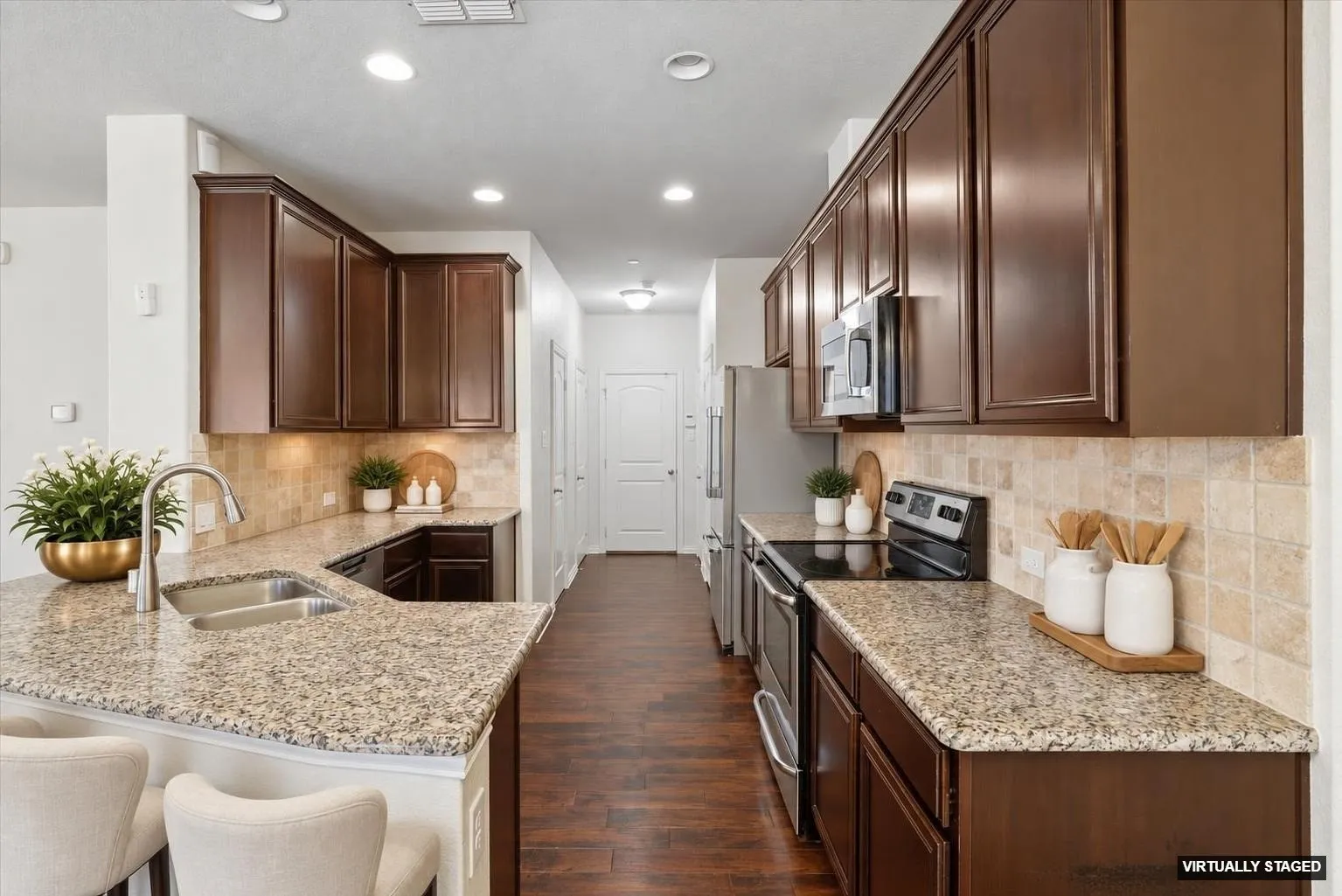 The Kitchen offers wood flooring, granite counter-tops and a decorator tile backsplash (Virtually Staged).
