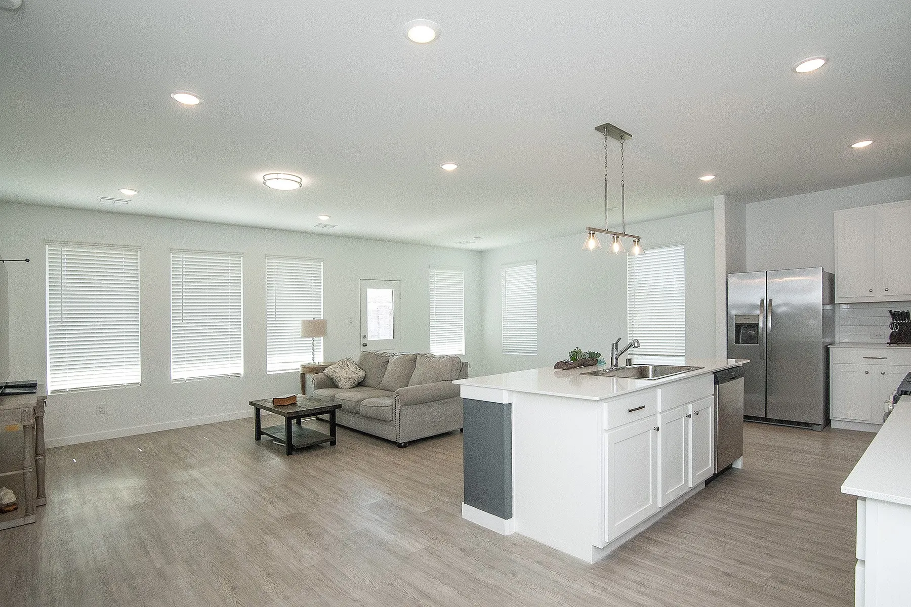 Open concept living space with wood-finish flooring