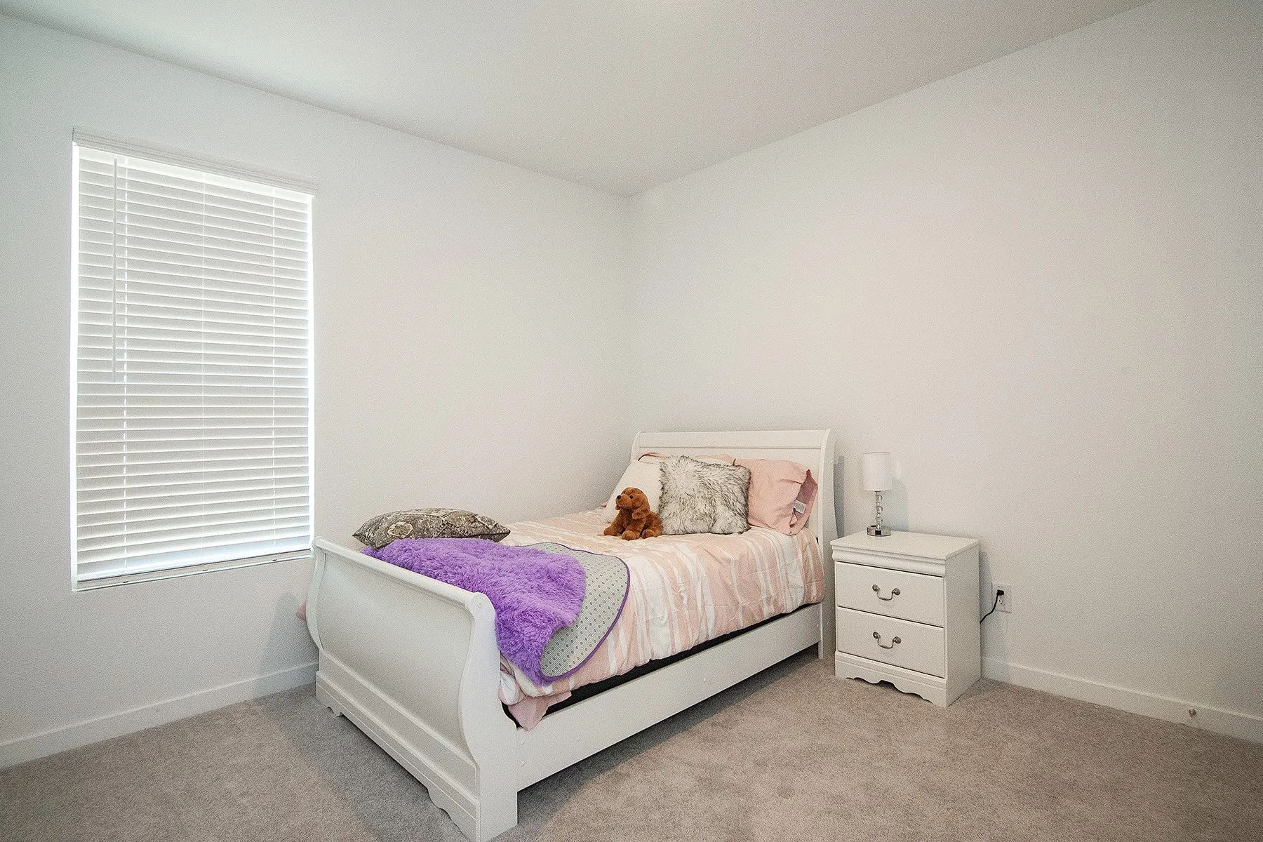 Carpet flooring, white walls, and a window with blinds