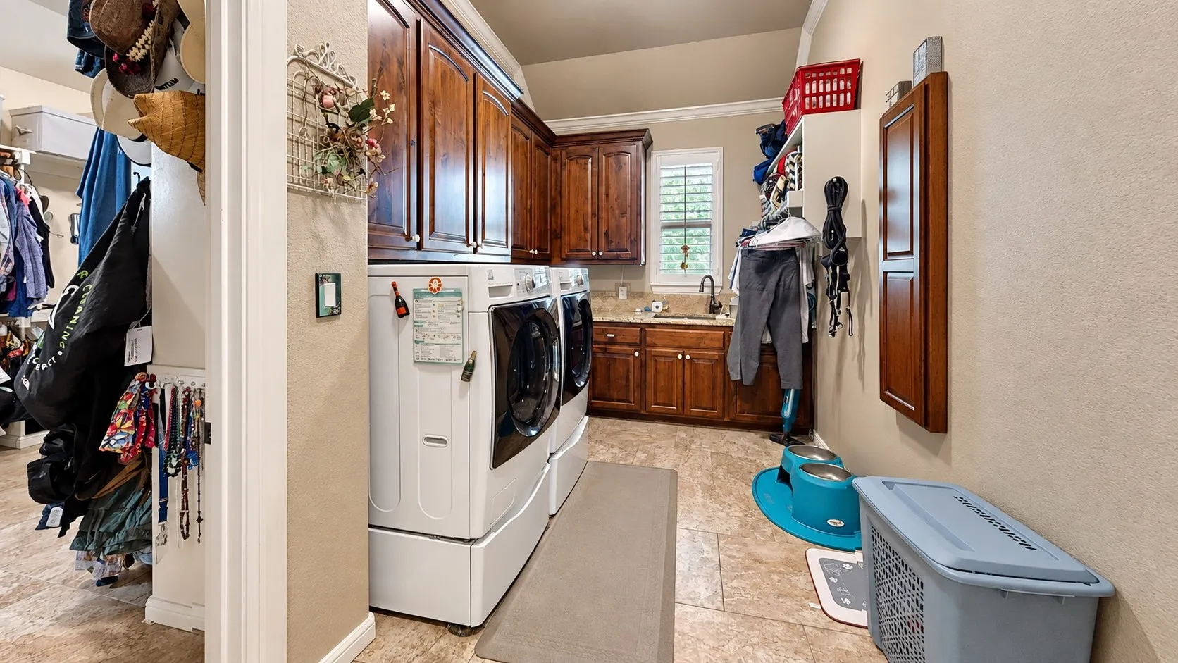 Laundry room attached to the primary walk-in closet
