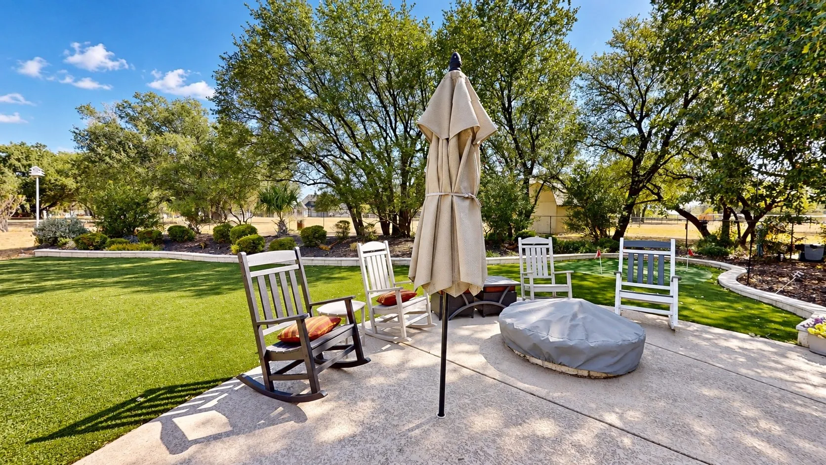 Patio overlooking the pool and one of the putting greens