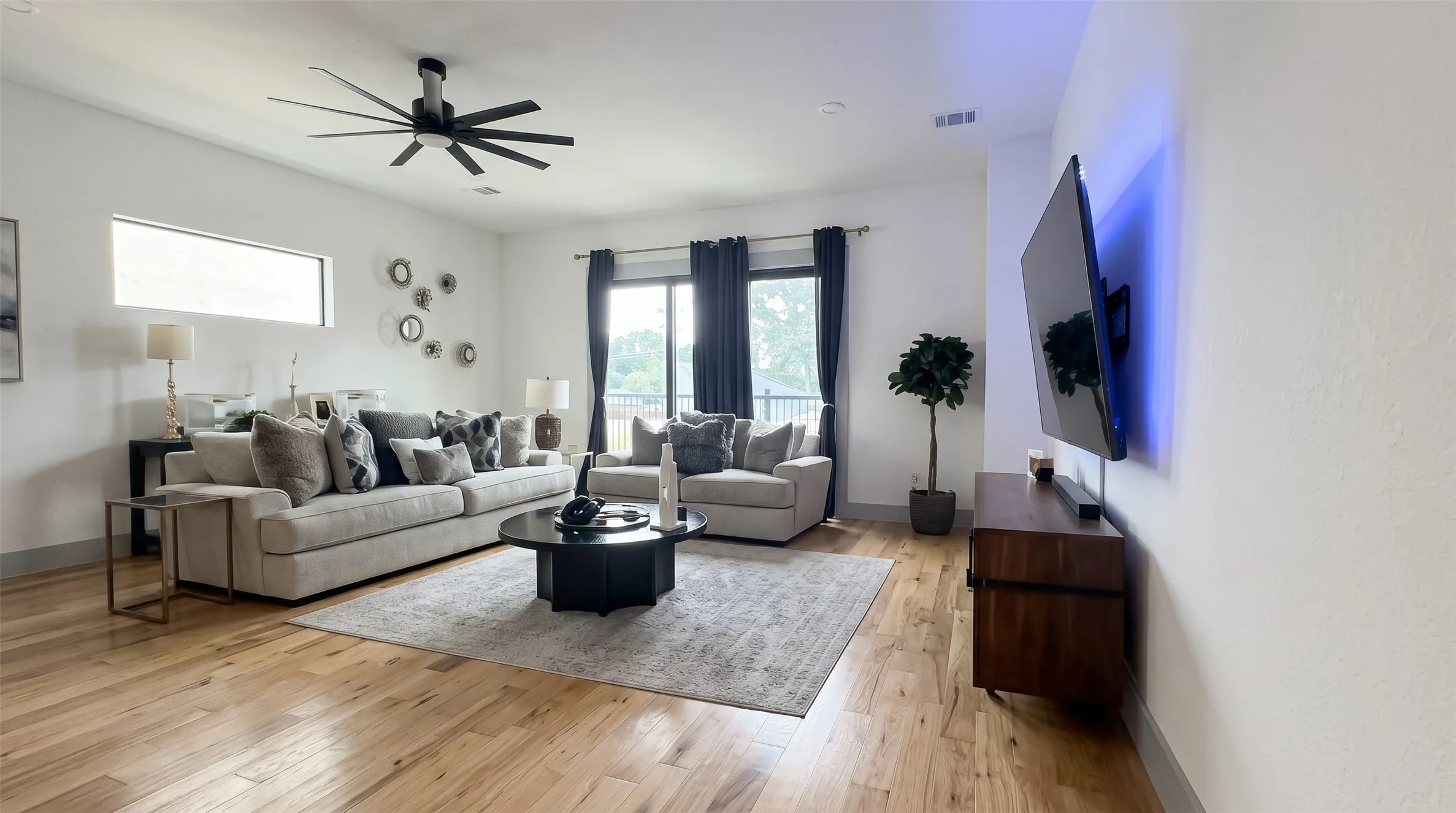 Hardwood flooring, high ceilings with a modern ceiling fan, recessed lighting, and a sliding glass door