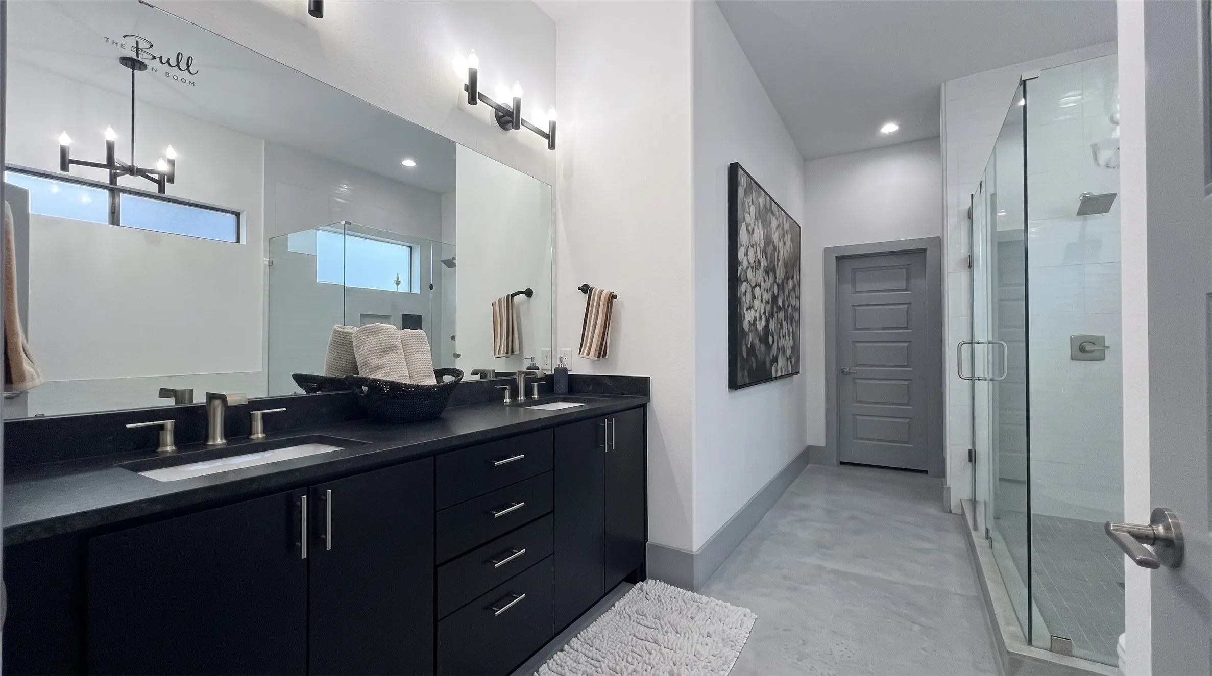 Dual vanity with dark cabinetry, integrated sinks, and brushed nickel fixtures