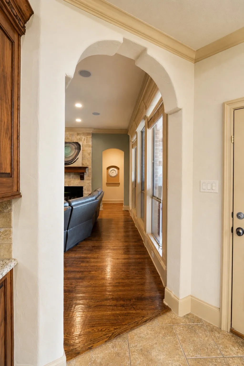 Arched entryway featuring recessed lighting and crown molding