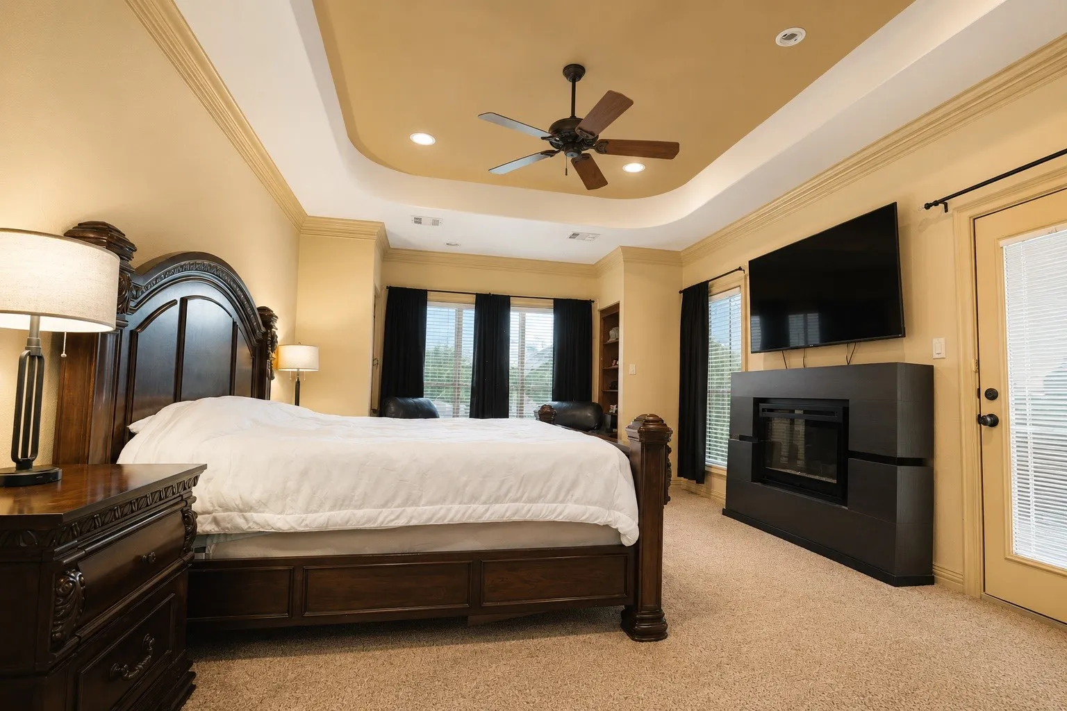 Coved ceiling with recessed lighting and ceiling fan
