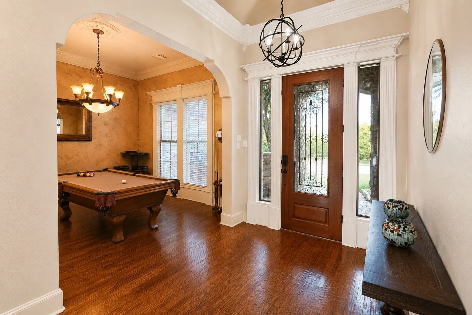 Rich wood-finish flooring throughout the entryway