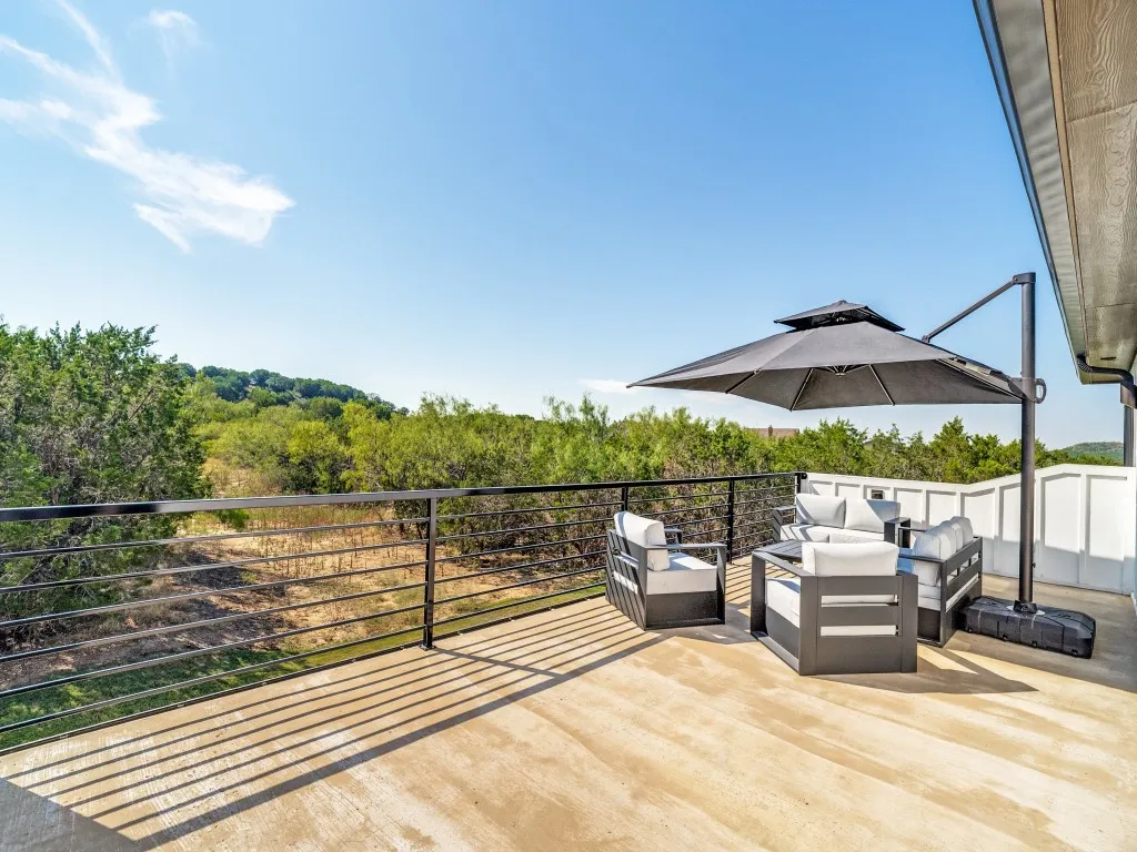Expansive concrete outdoor deck with metal railing