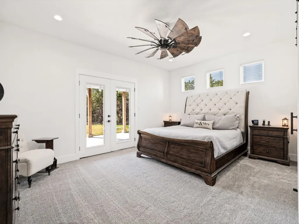 Dual glass-panel doors, recessed lighting, and a decorative ceiling fan