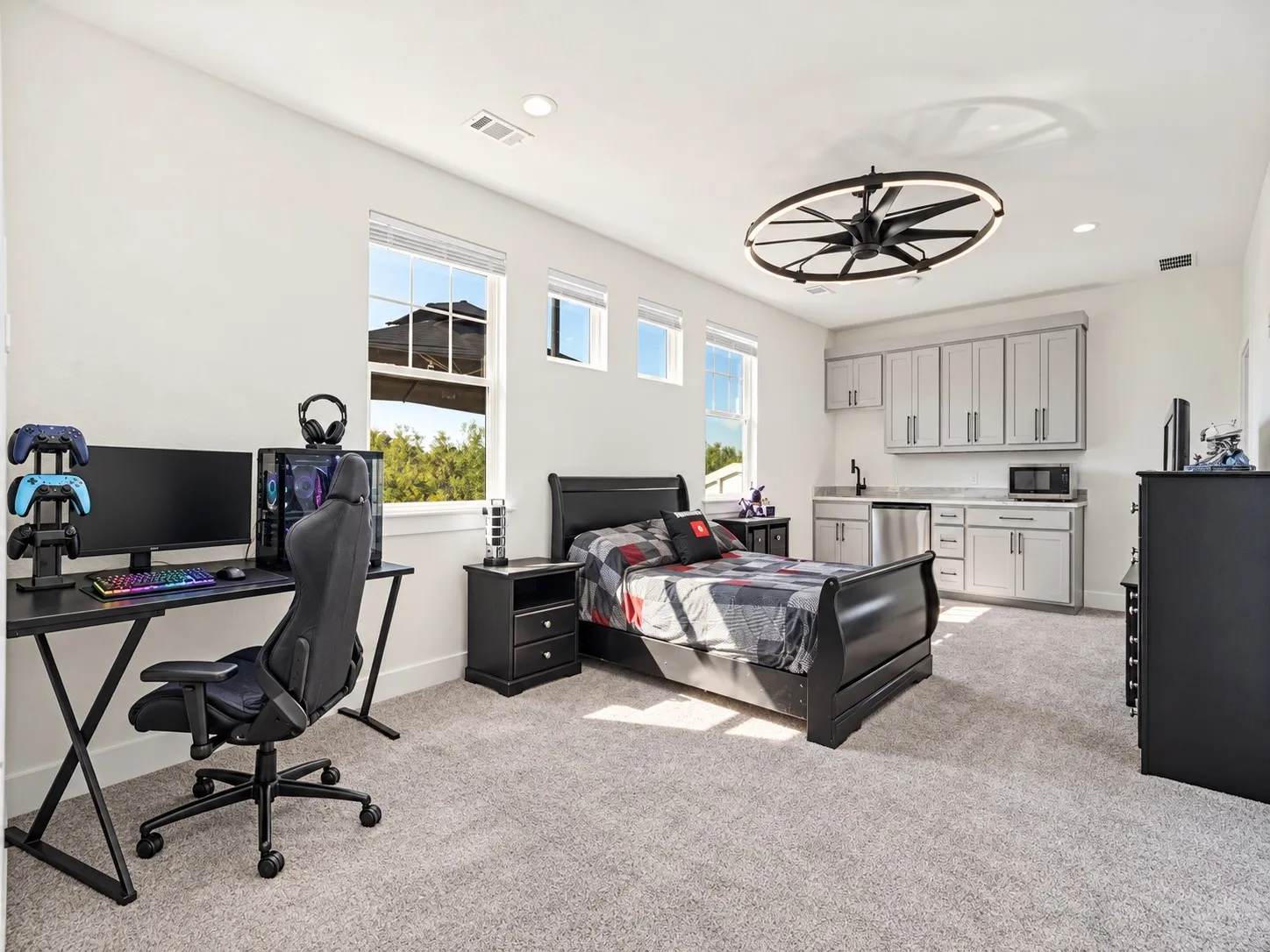 Spacious private studio with room for sleeping, gaming, or relaxing, plus a kitchenette and adjoining bathroom.