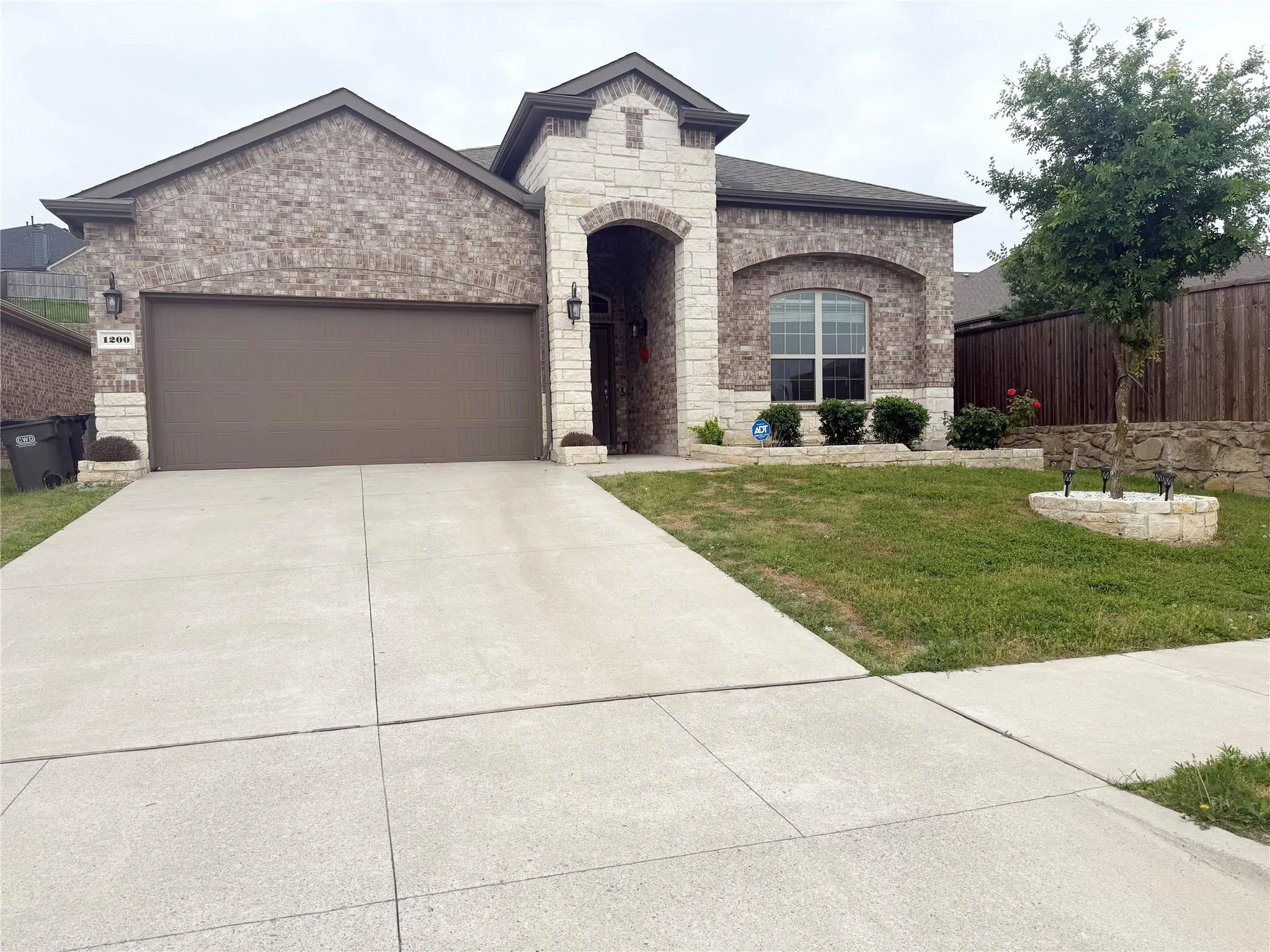 Brick and stone exterior with an arched entryway