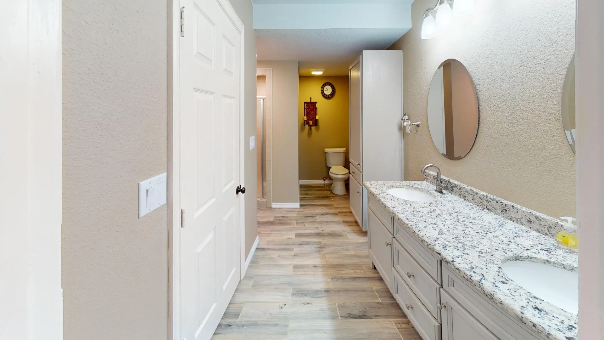 Dual vanity with undermount sinks and light-colored countertops