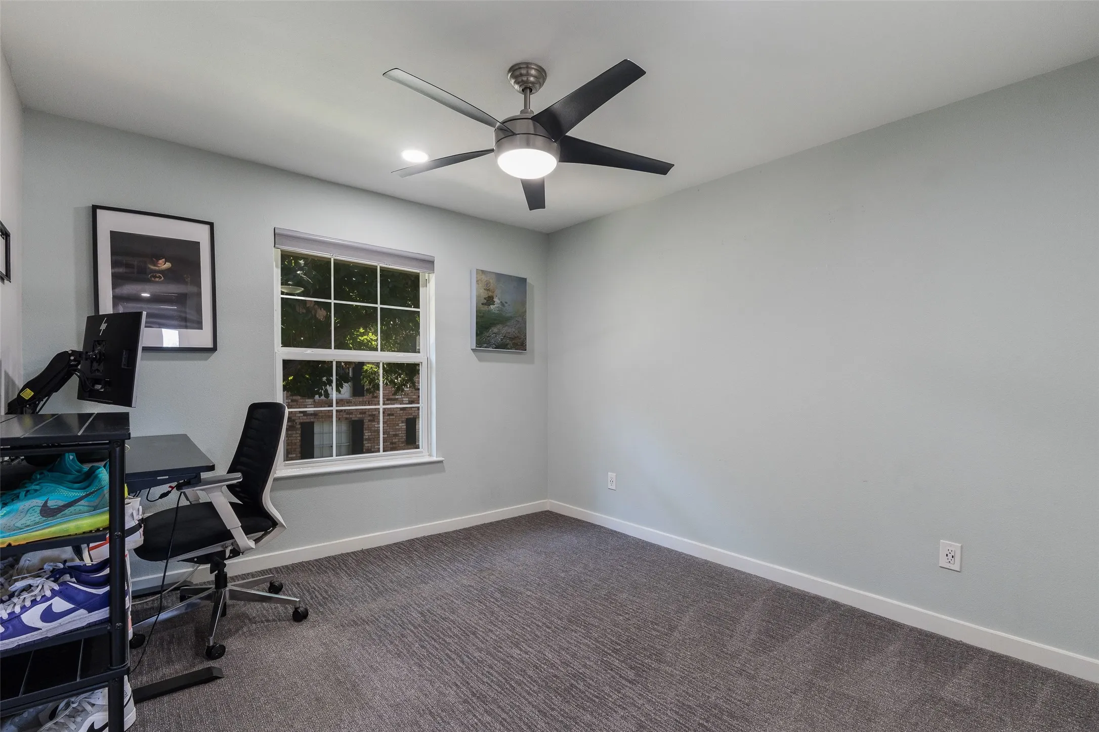 Recessed lighting, ceiling fan with integrated light, window with white trim, and gray patterned carpeting