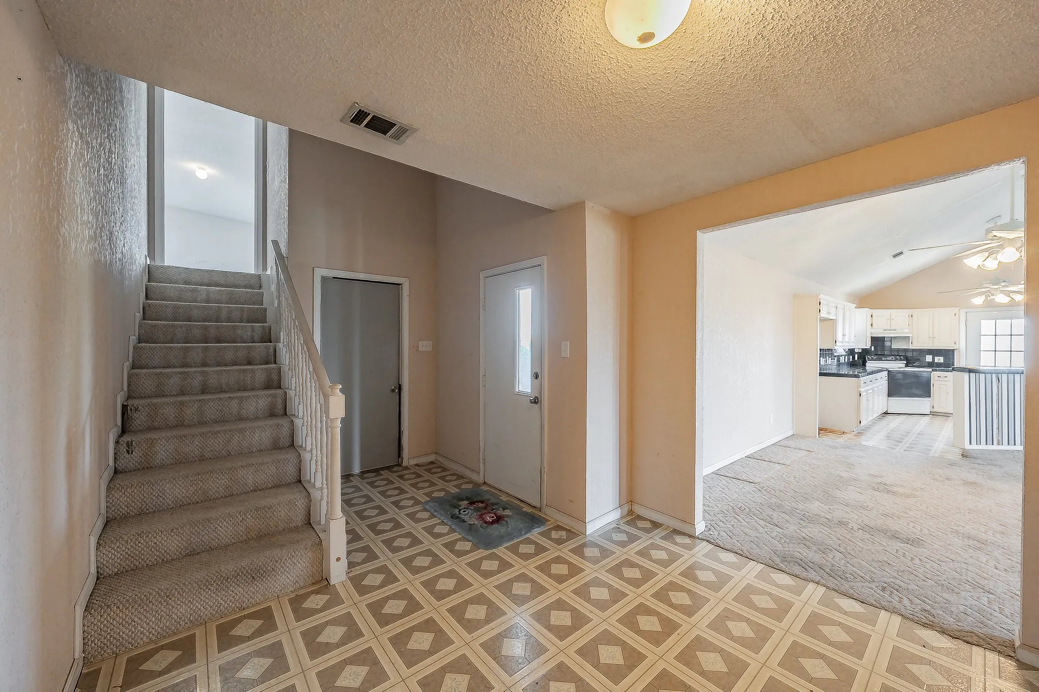 Entrance from garage and side door leading to upstairs area