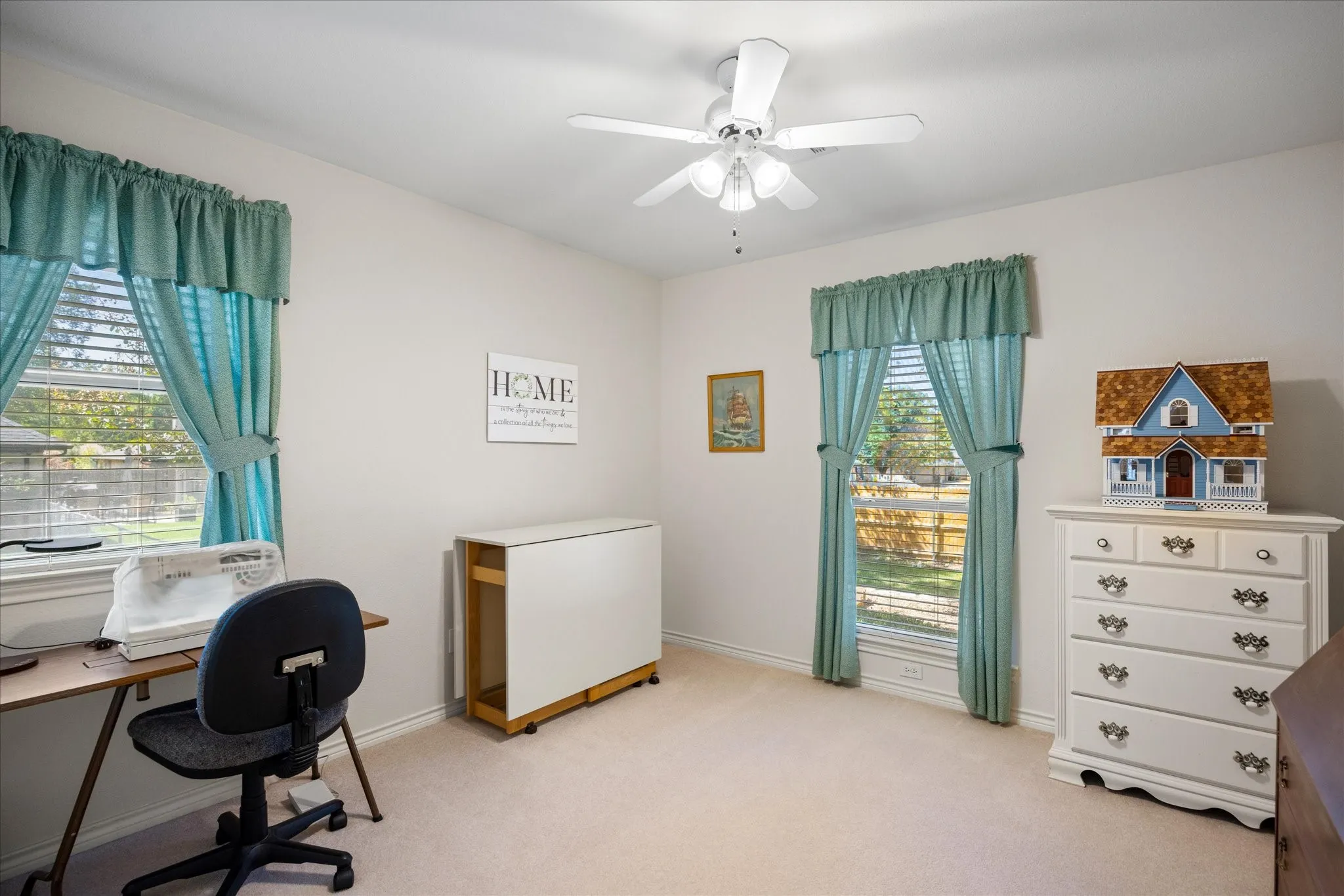 Recessed lighting, ceiling fan, two windows with blinds, and light-colored carpet flooring