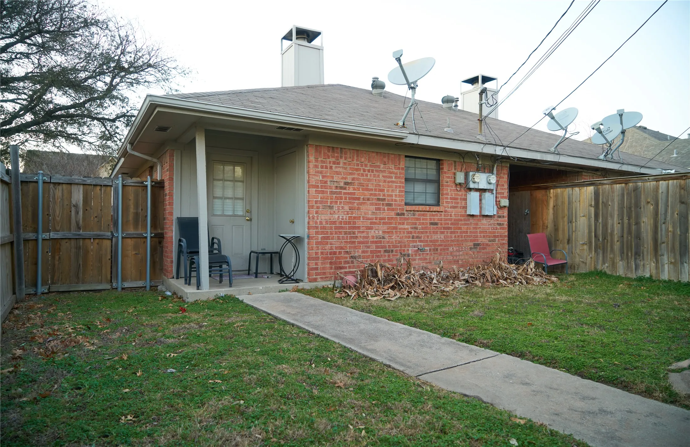 Back of house with a lawn