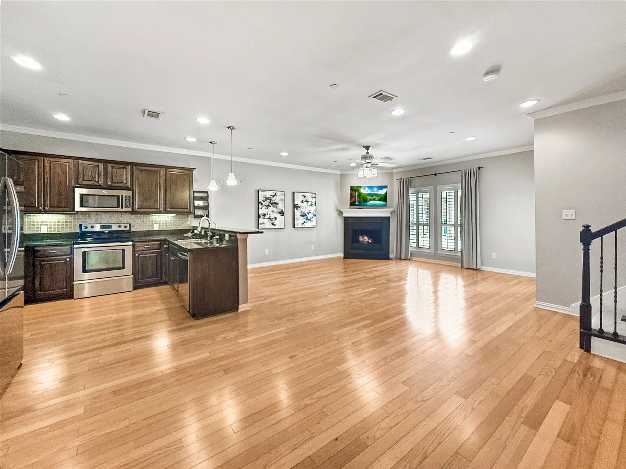 Expansive open-concept space featuring wood-finish flooring throughout