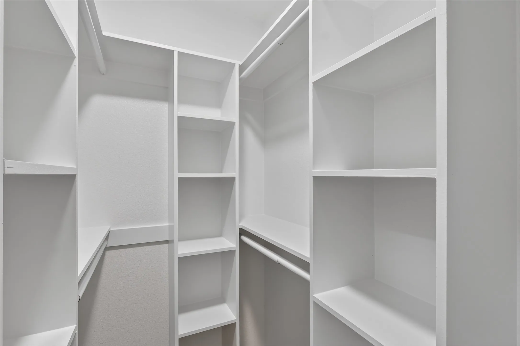 Built-in closet system featuring multiple shelves and hanging rods