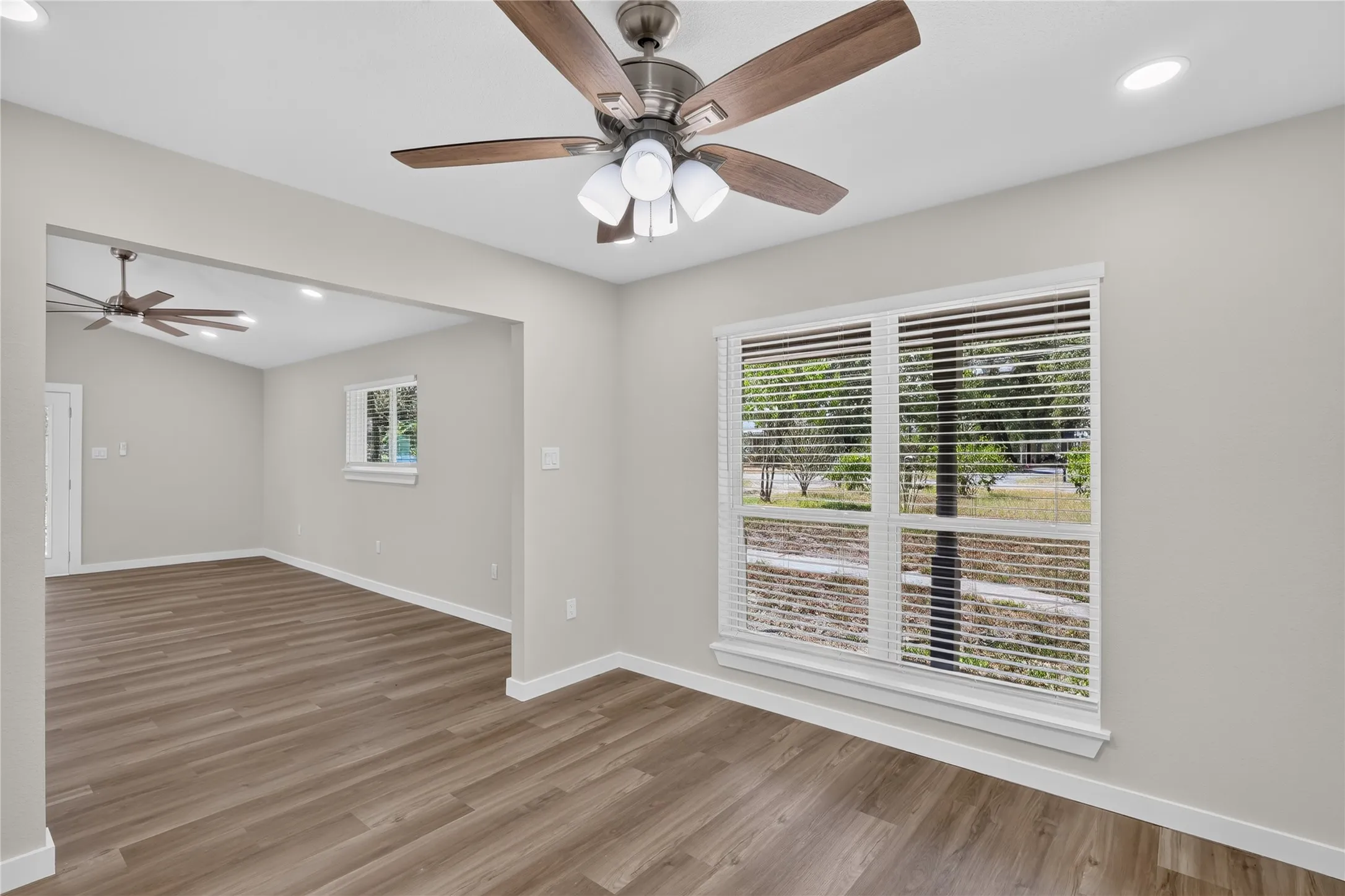Wood-finish flooring throughout, paired with light gray wall finishes