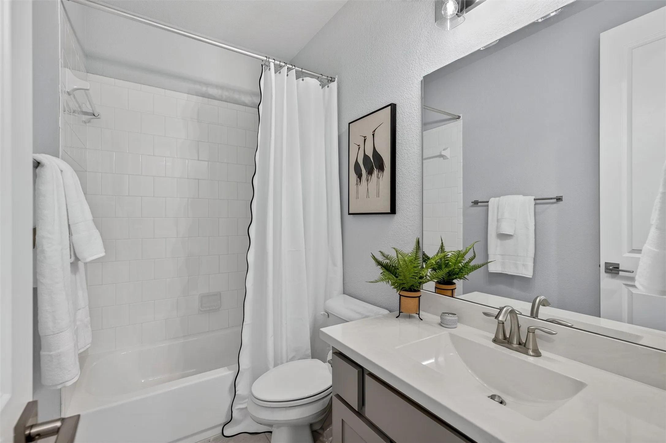 Vanity with integrated sink and brushed nickel faucet
