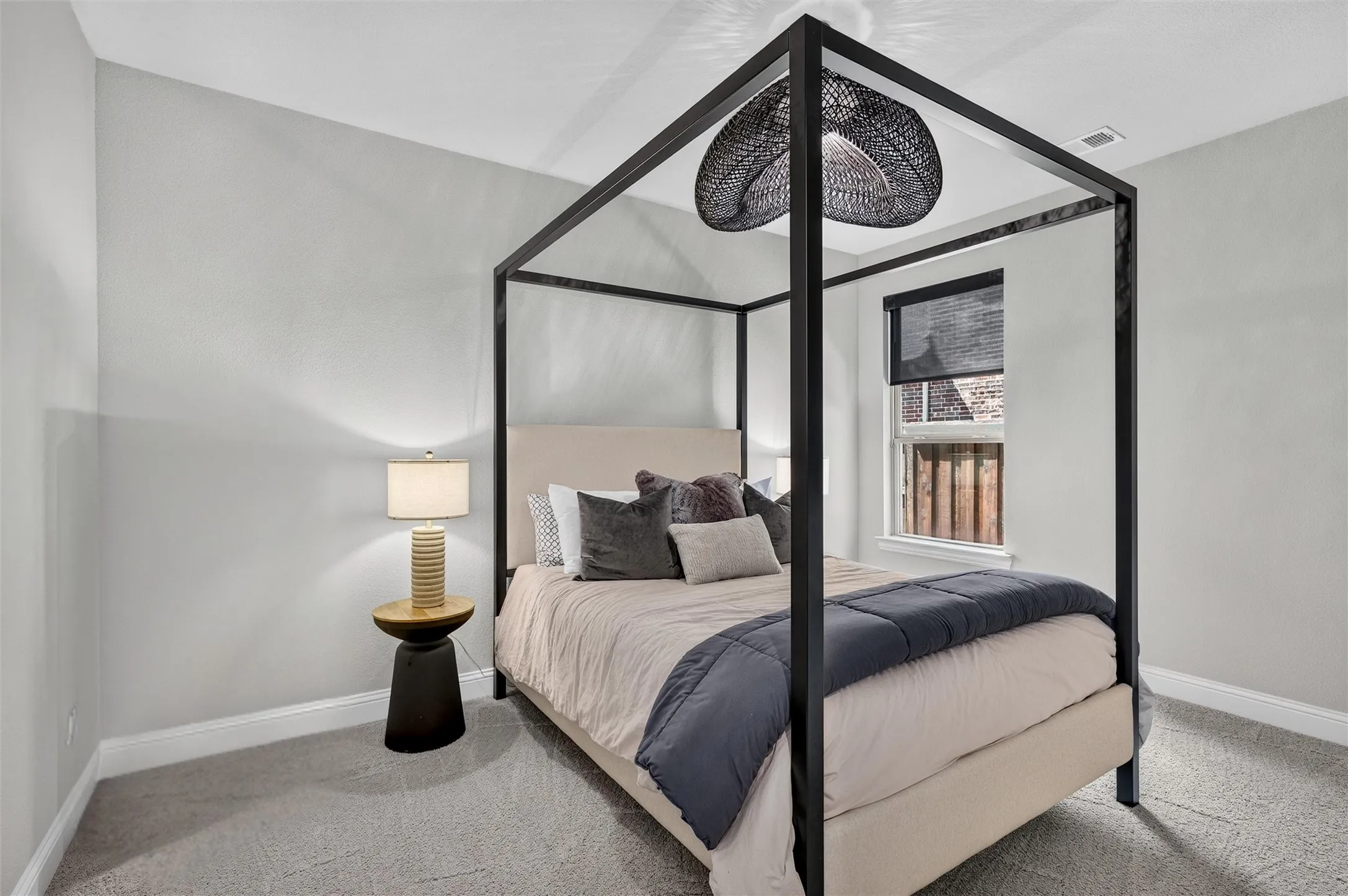 Recessed lighting, carpeted flooring, and a window with roller shade