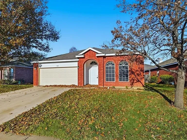 Red brick facade with arched entry and window details
