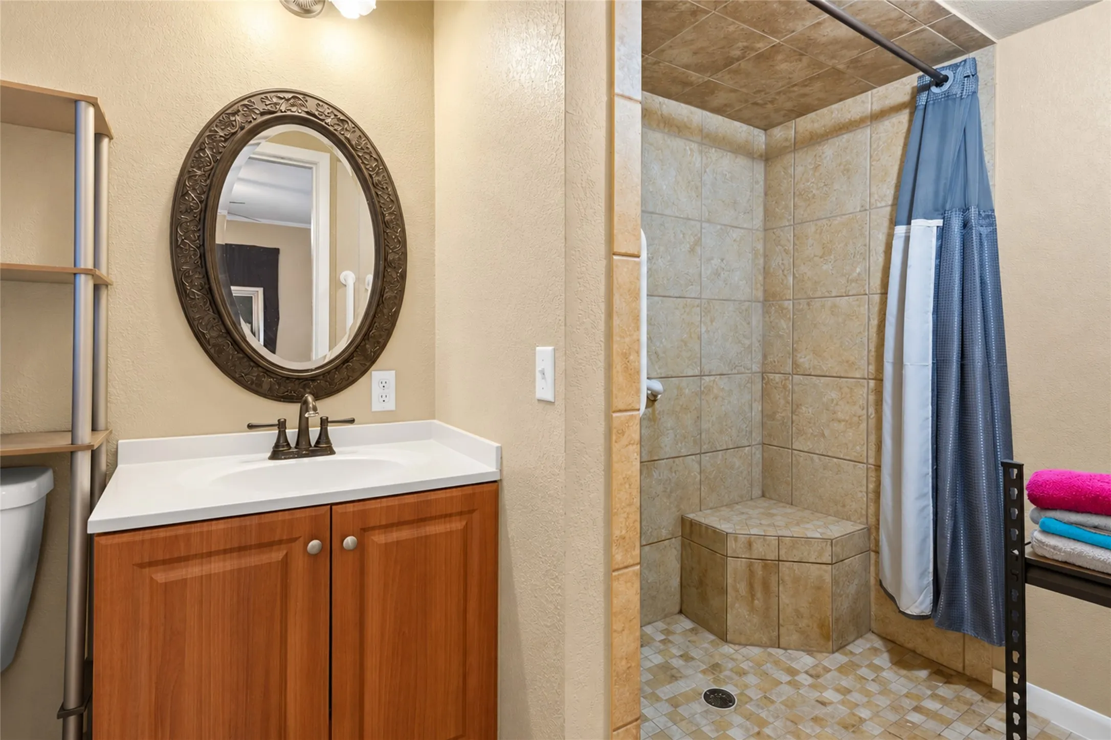 Tiled walk-in shower with a built-in bench