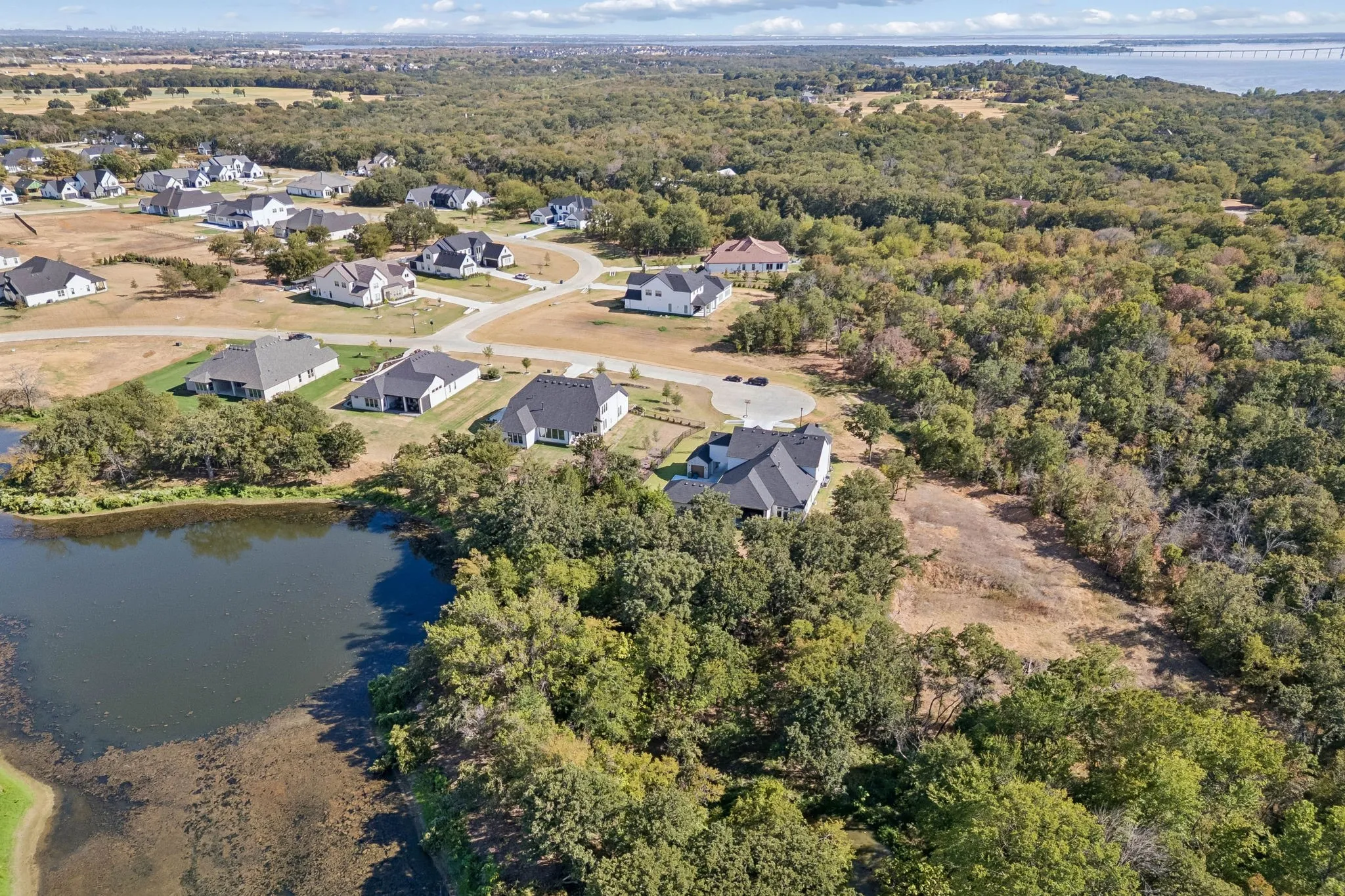 Residential community with mature trees and a tranquil pond