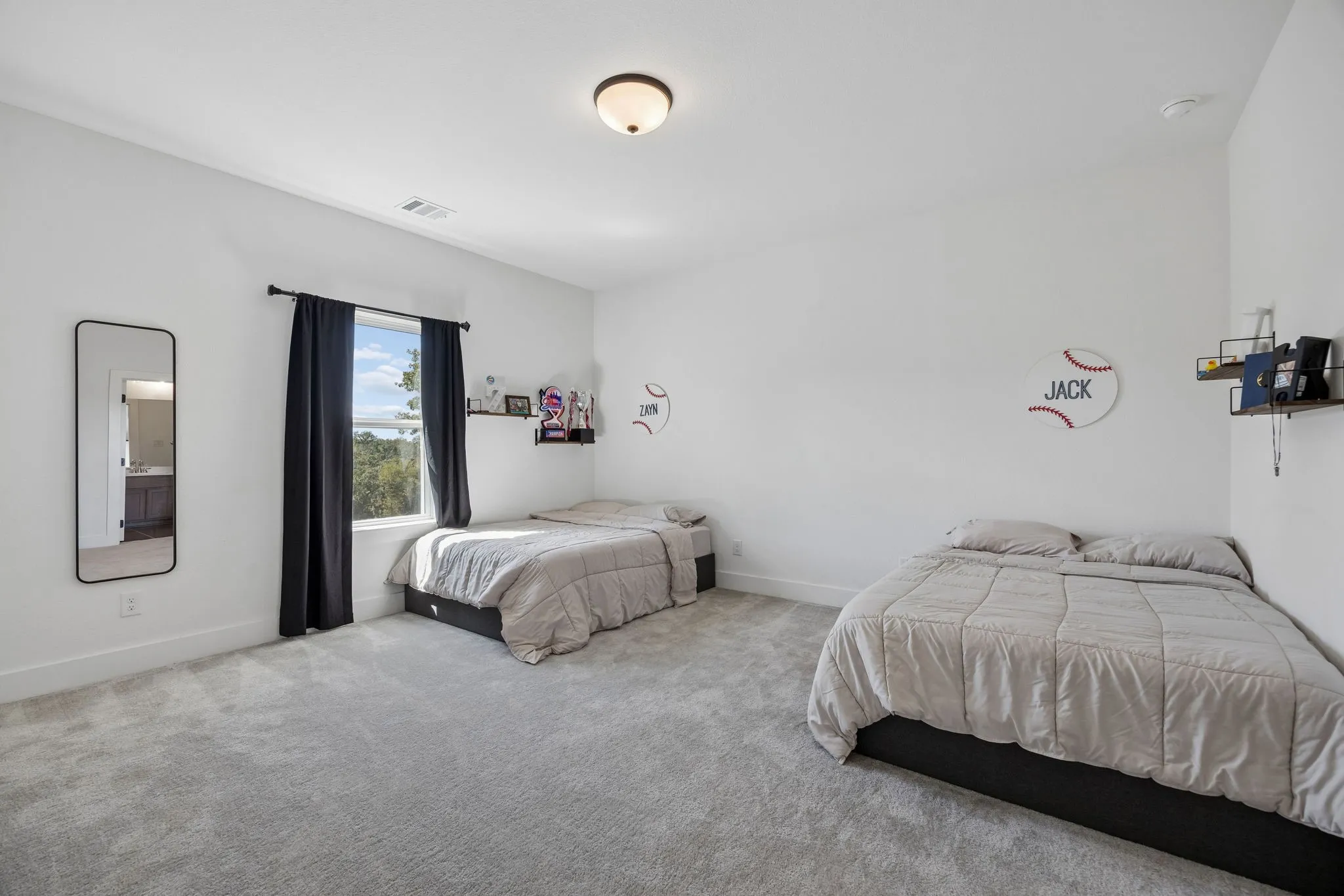 Neutral color palette, wall-to-wall carpeting, recessed ceiling lighting, built-in shelving