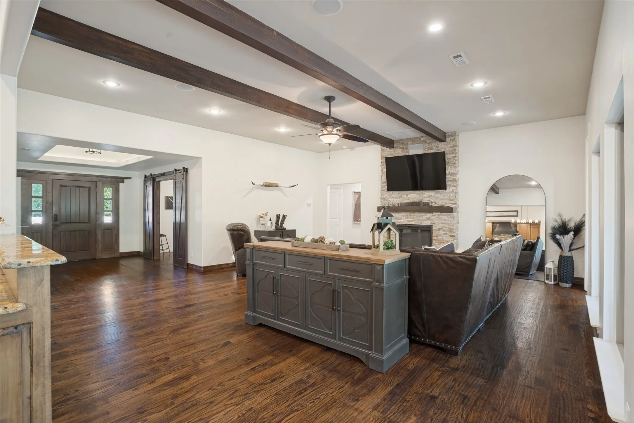 Huge living area boasts can lighting, wood beamed ceilings, fresh paint, refinished wood flooring.