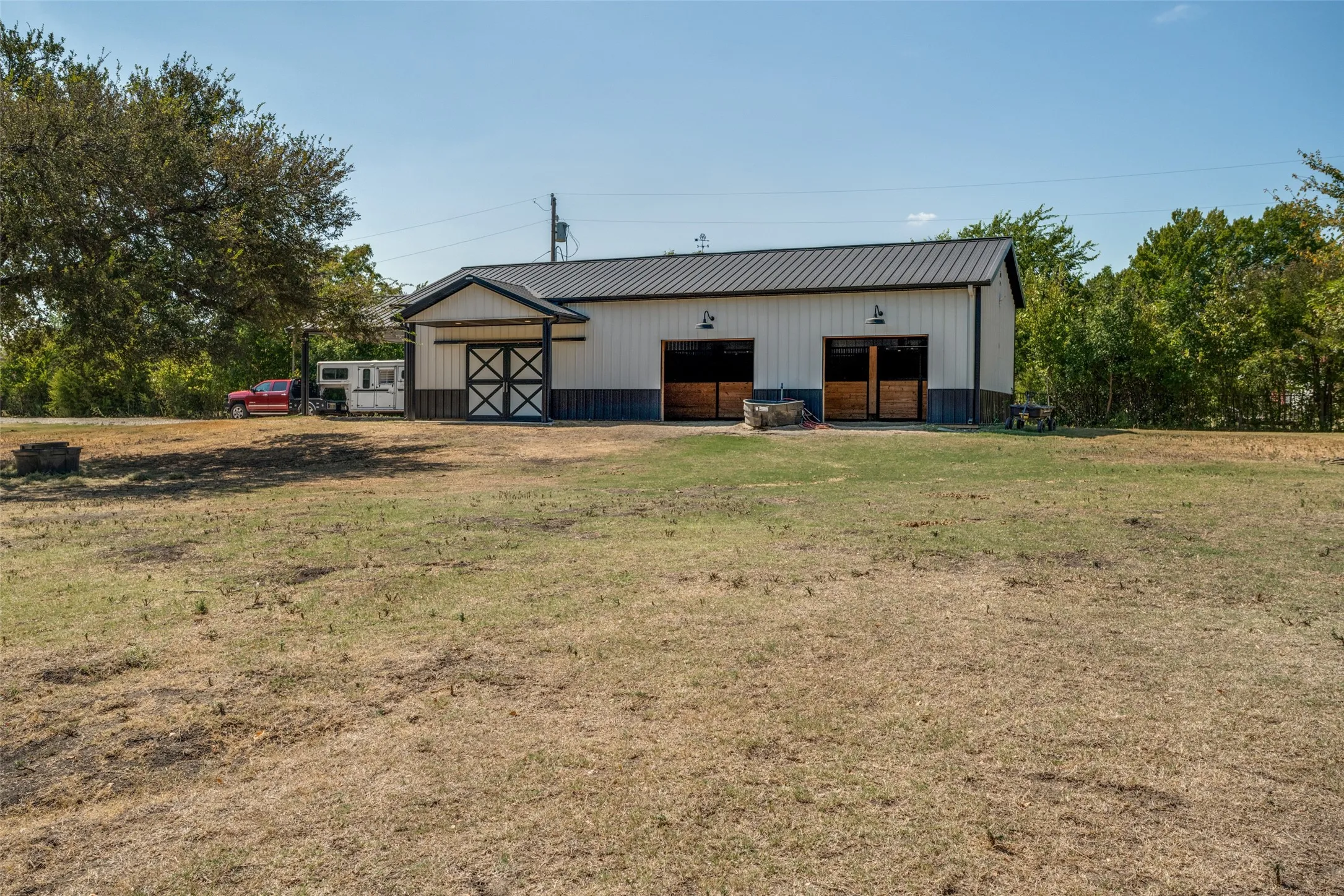 Custom barn / workshop was built in 2025.  Large pasture area surrounds the structure and provides plenty of space for your horses and livestock.