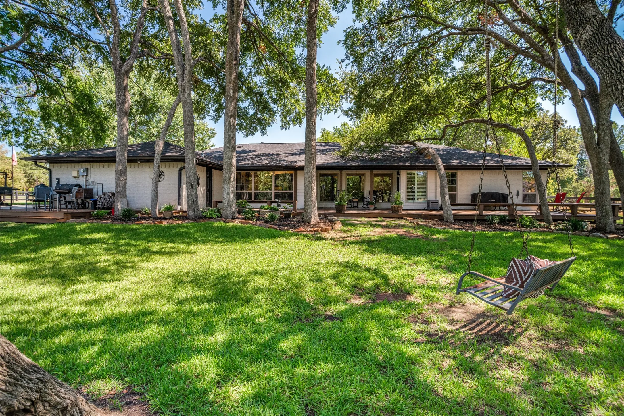 Beautiful back view of this amazing home.  Shaded back deck and stunning landscaping.