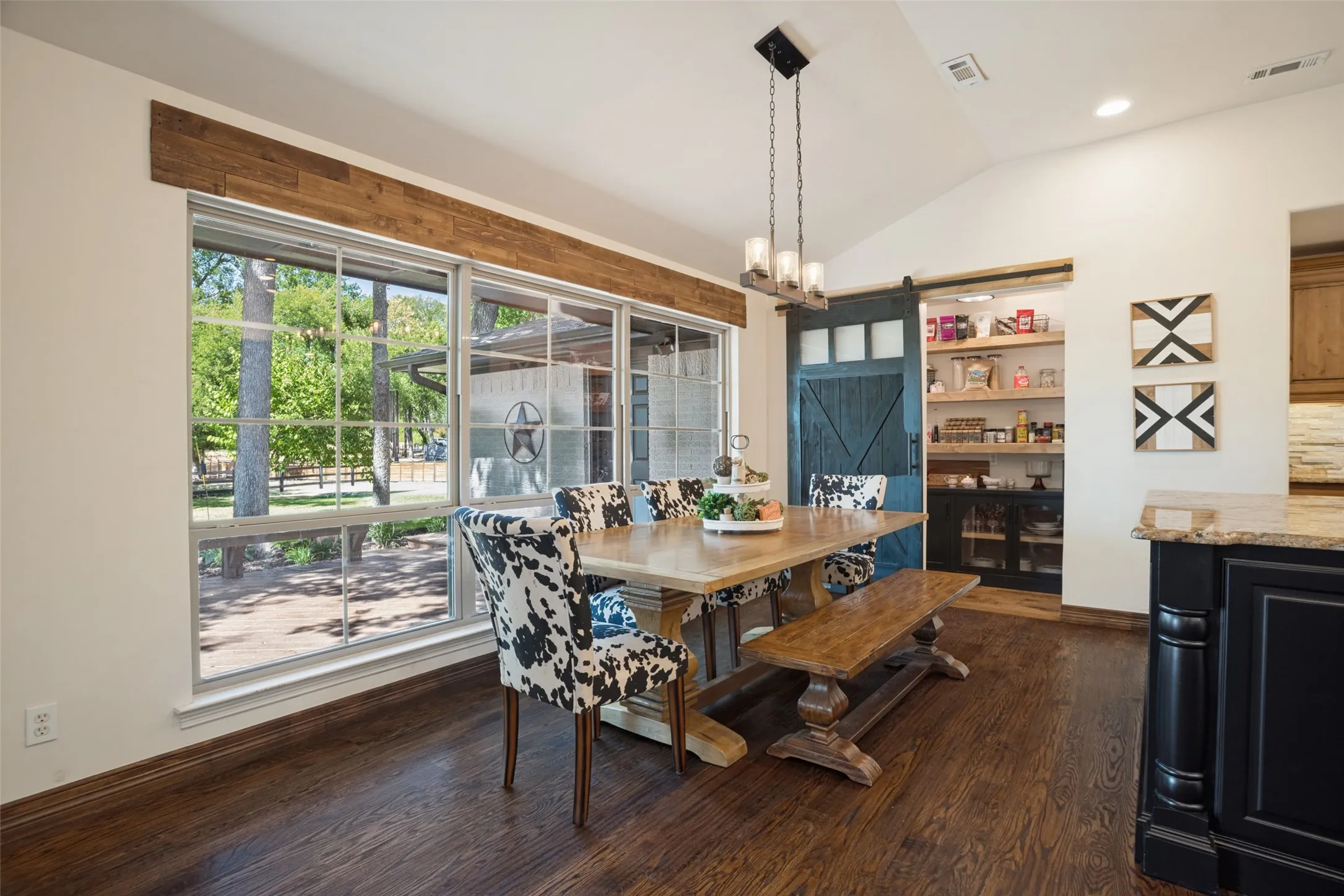 Oversized breakfast area with custom walk-in pantry beyond.  Beautiful views to back deck and yard.