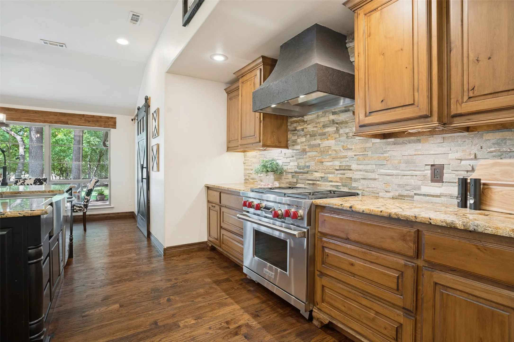 Wolf range and oven with 4 burners and griddle.