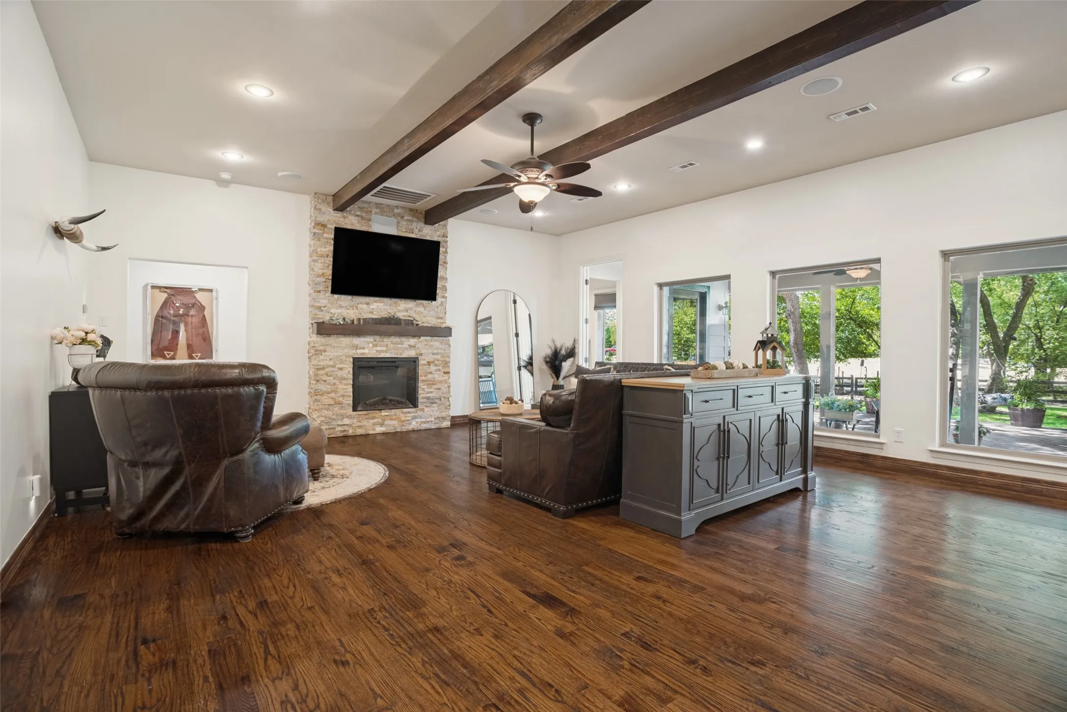 So many upgrades to this beautiful home!  The fireplace and wall of windows to the backyard are some of the homeowners' favorites.