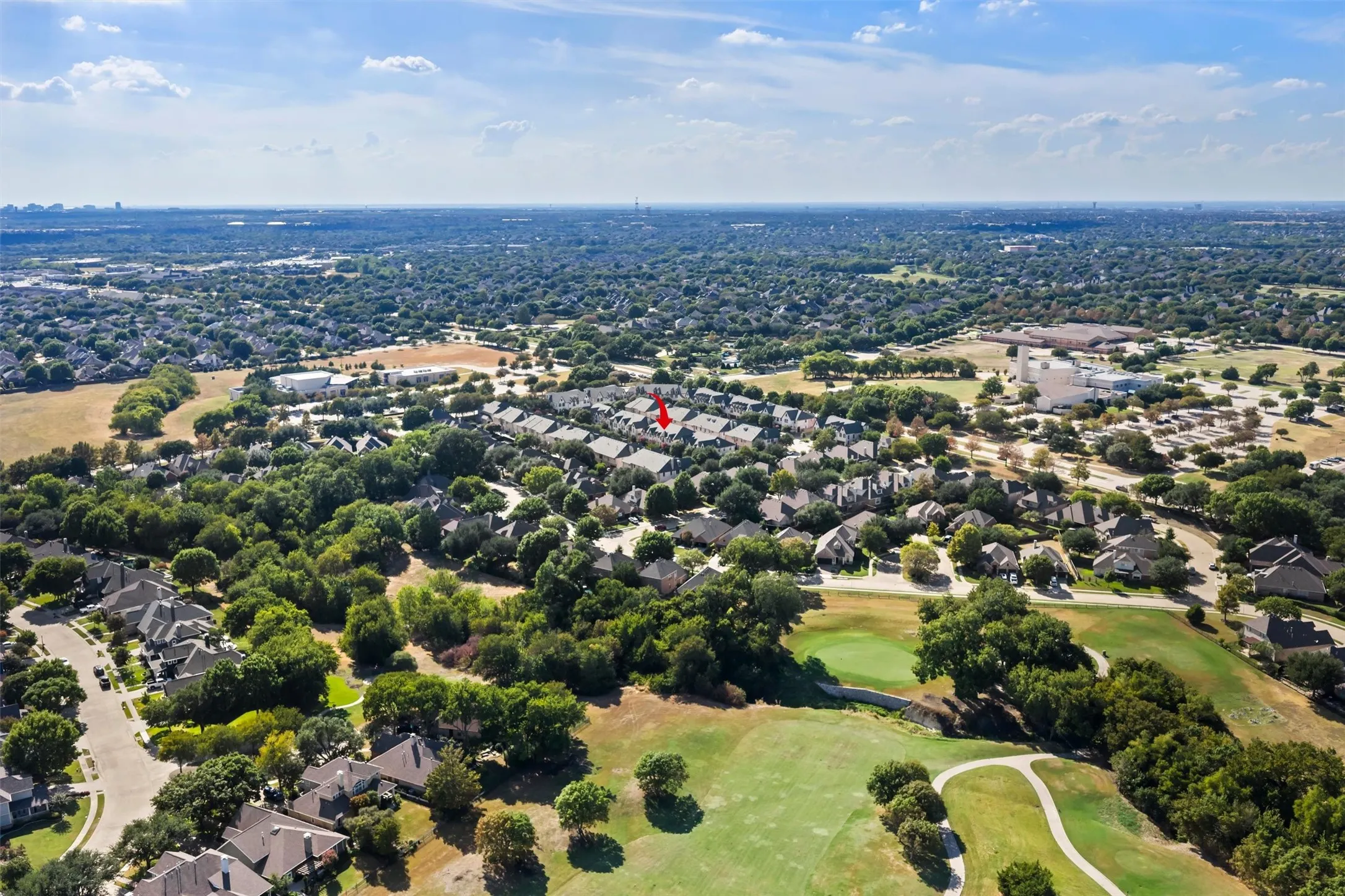 Expansive neighborhood featuring mature trees, residential properties, and a golf course