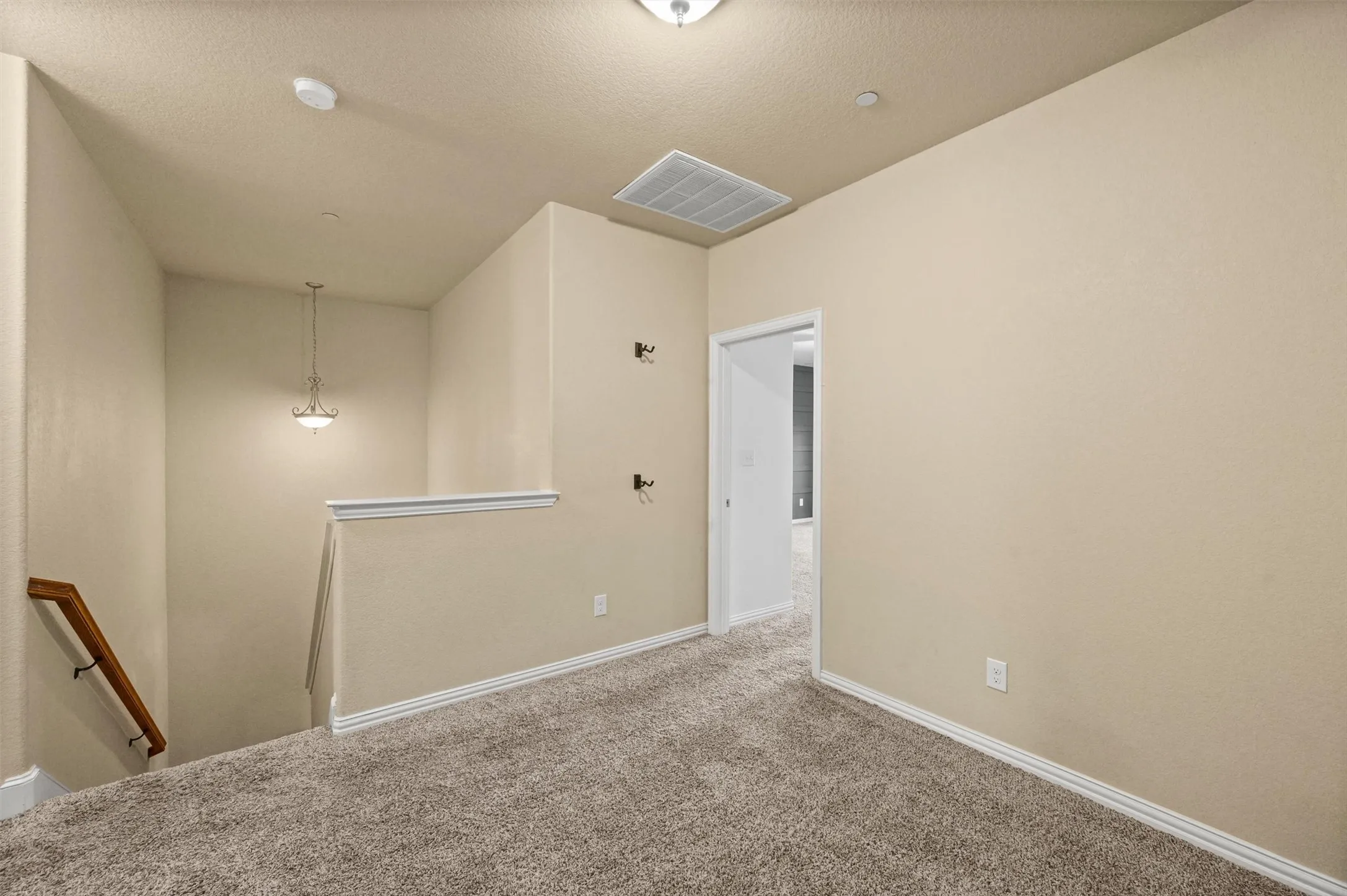 Carpeted flooring, neutral wall tones, white trim, and a ceiling-mounted light fixture