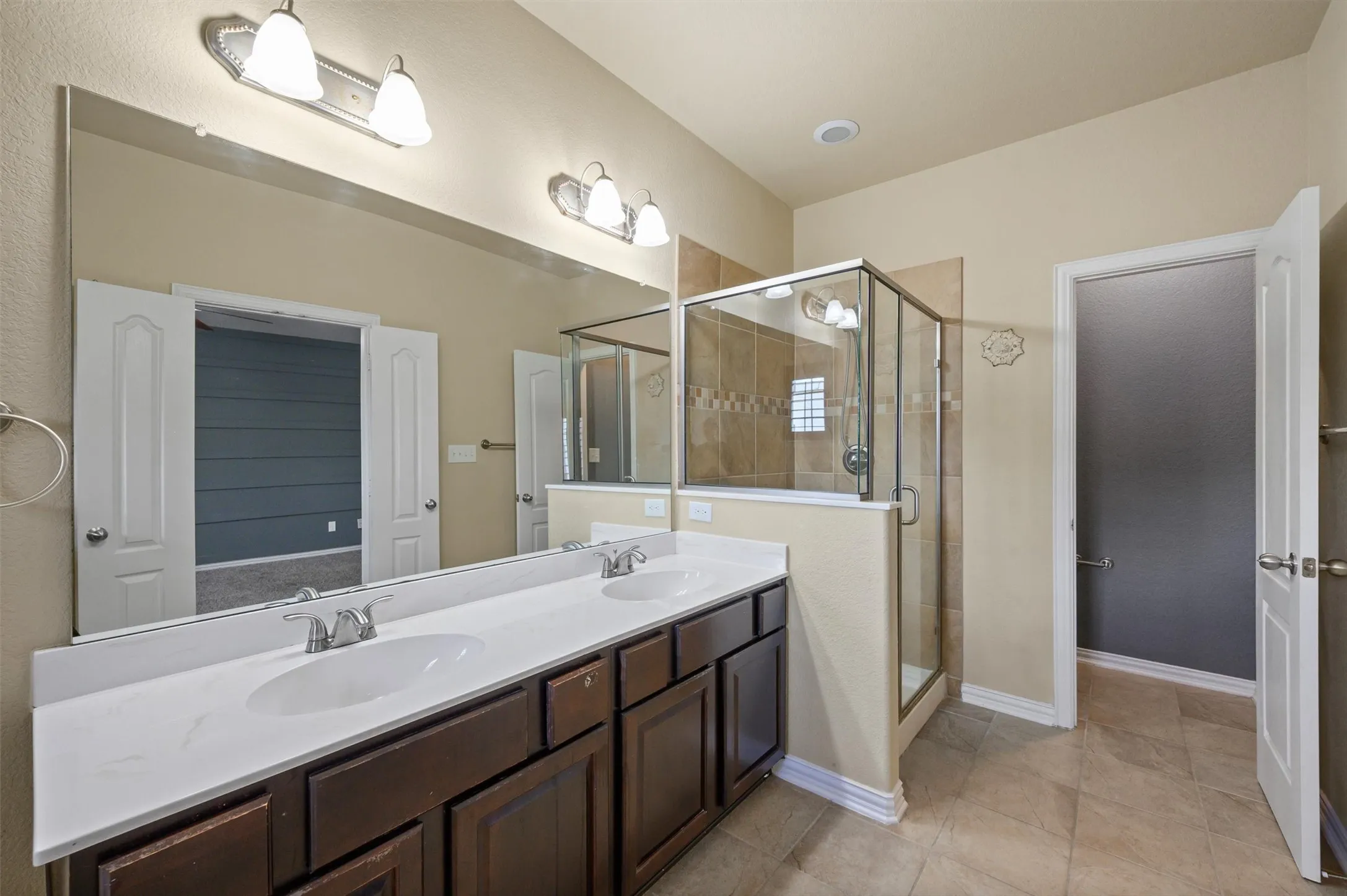 Dual vanity with undermount sinks and dark wood-finish cabinetry
