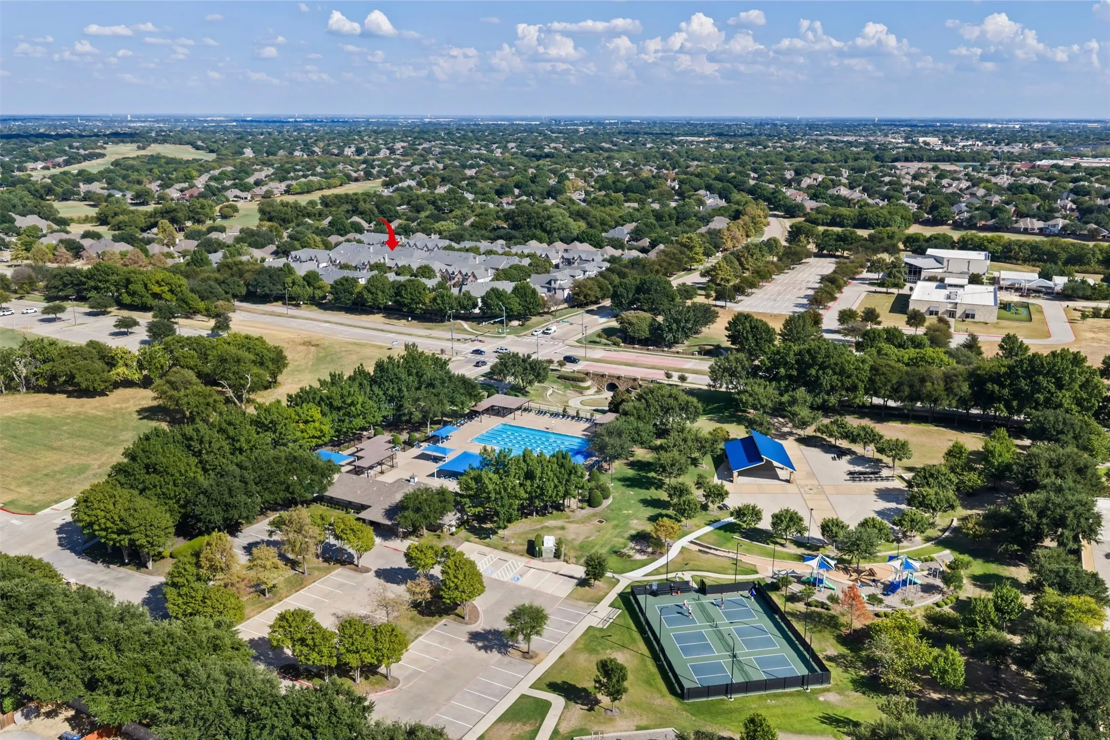 Community amenities including a swimming pool, tennis courts, and recreational green spaces