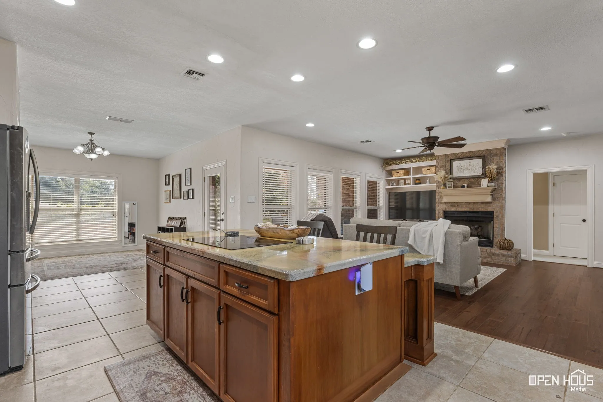 Kitchen island with built-in cooktop and granite-style countertop