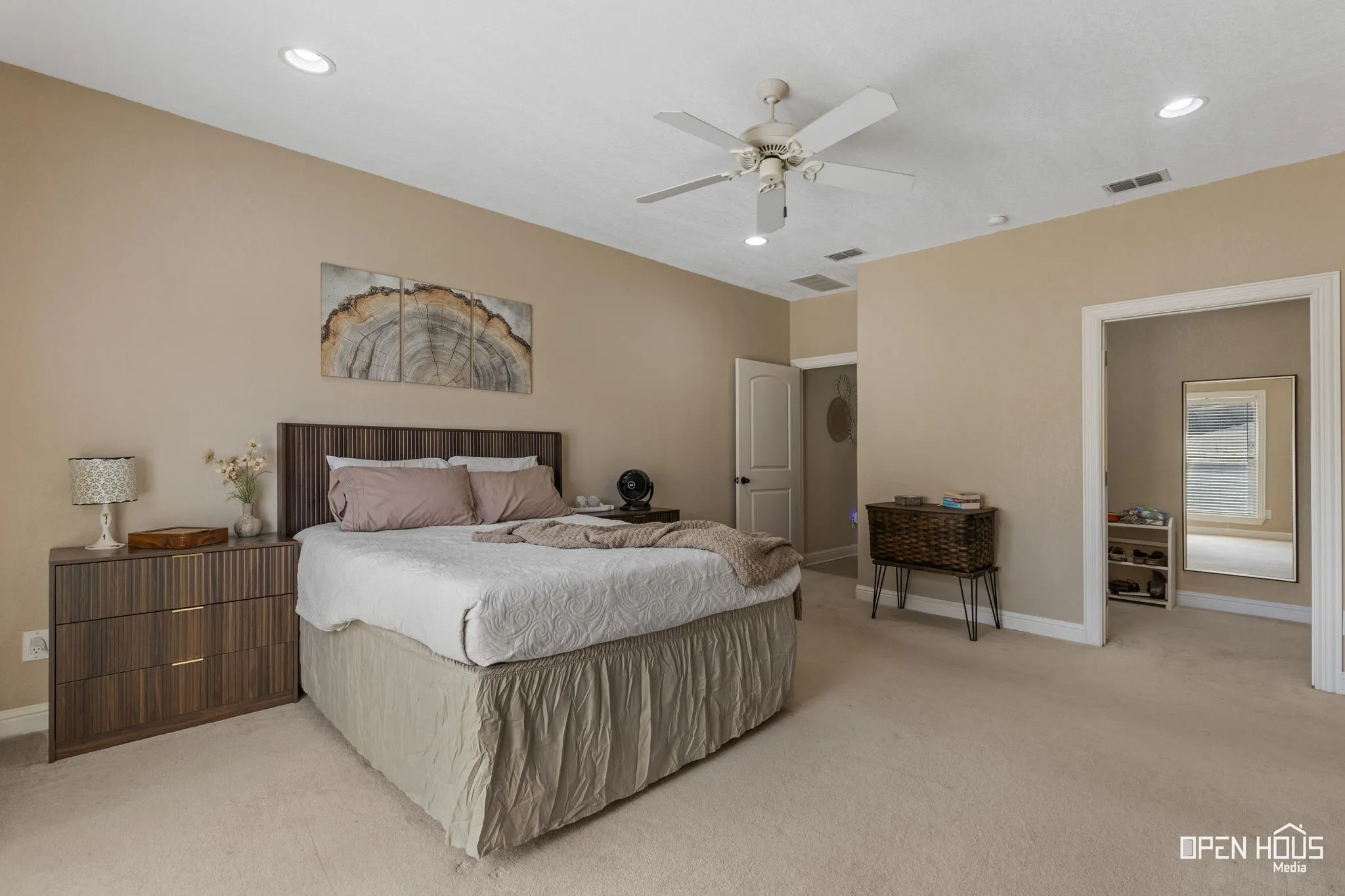 Recessed lighting, ceiling fan, and light-toned wall paint
