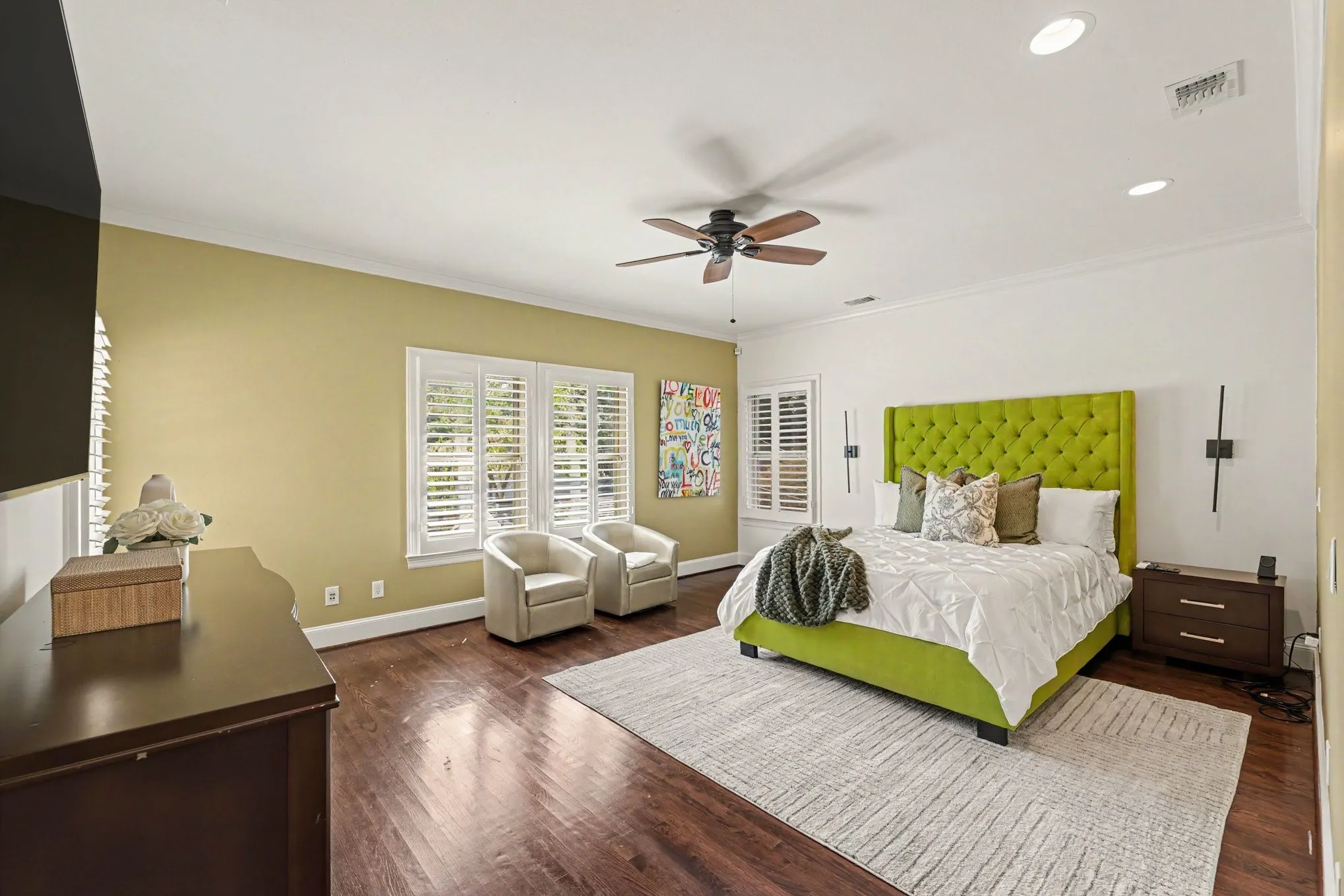 Hardwood flooring, recessed lighting, crown molding, ceiling fan, and plantation shutters