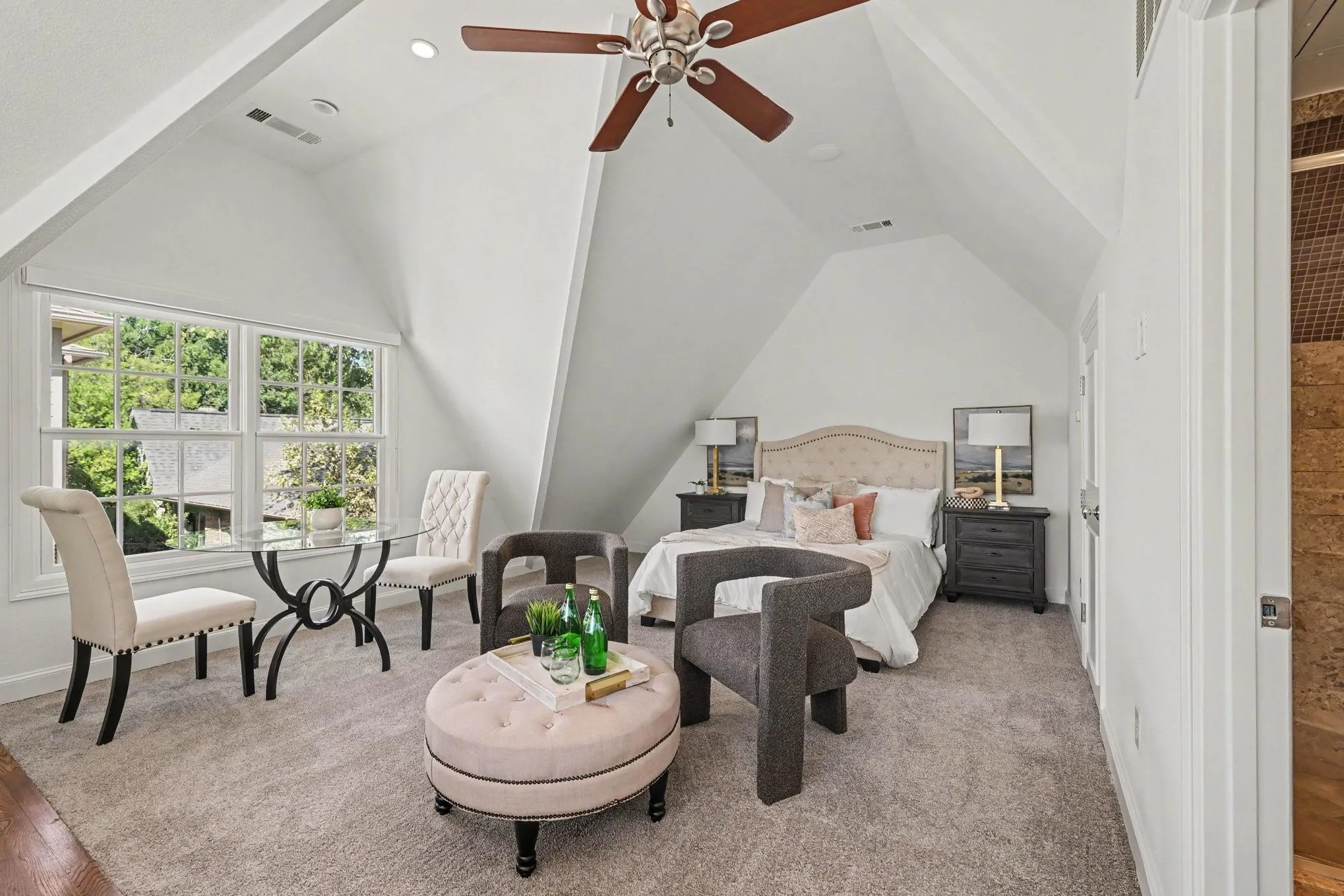 Angled ceilings, double-hung windows, recessed lighting, ceiling fan, and carpeted flooring