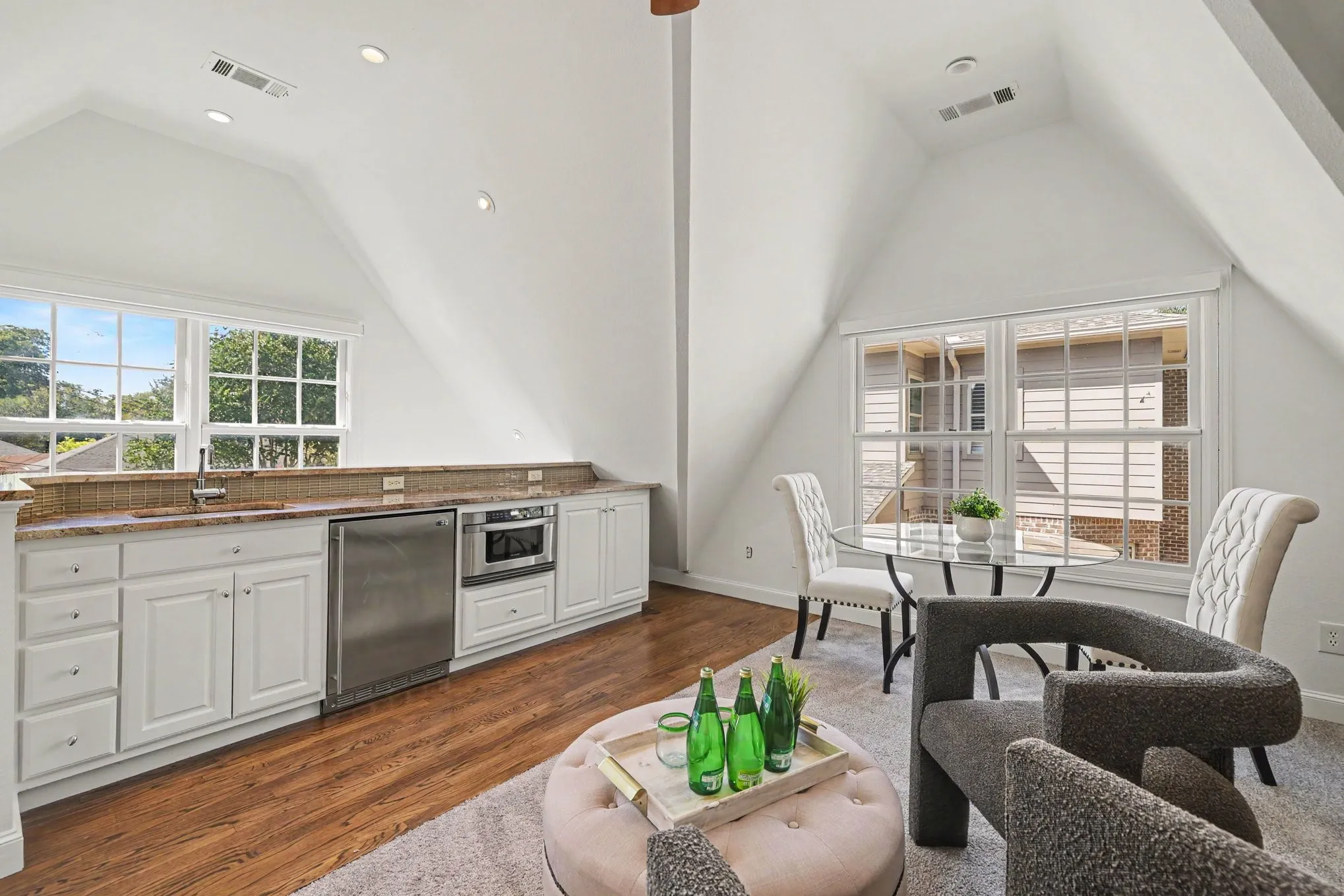 Attic space featuring white built-in cabinetry, granite-style countertops, wood-finish flooring, and recessed lighting