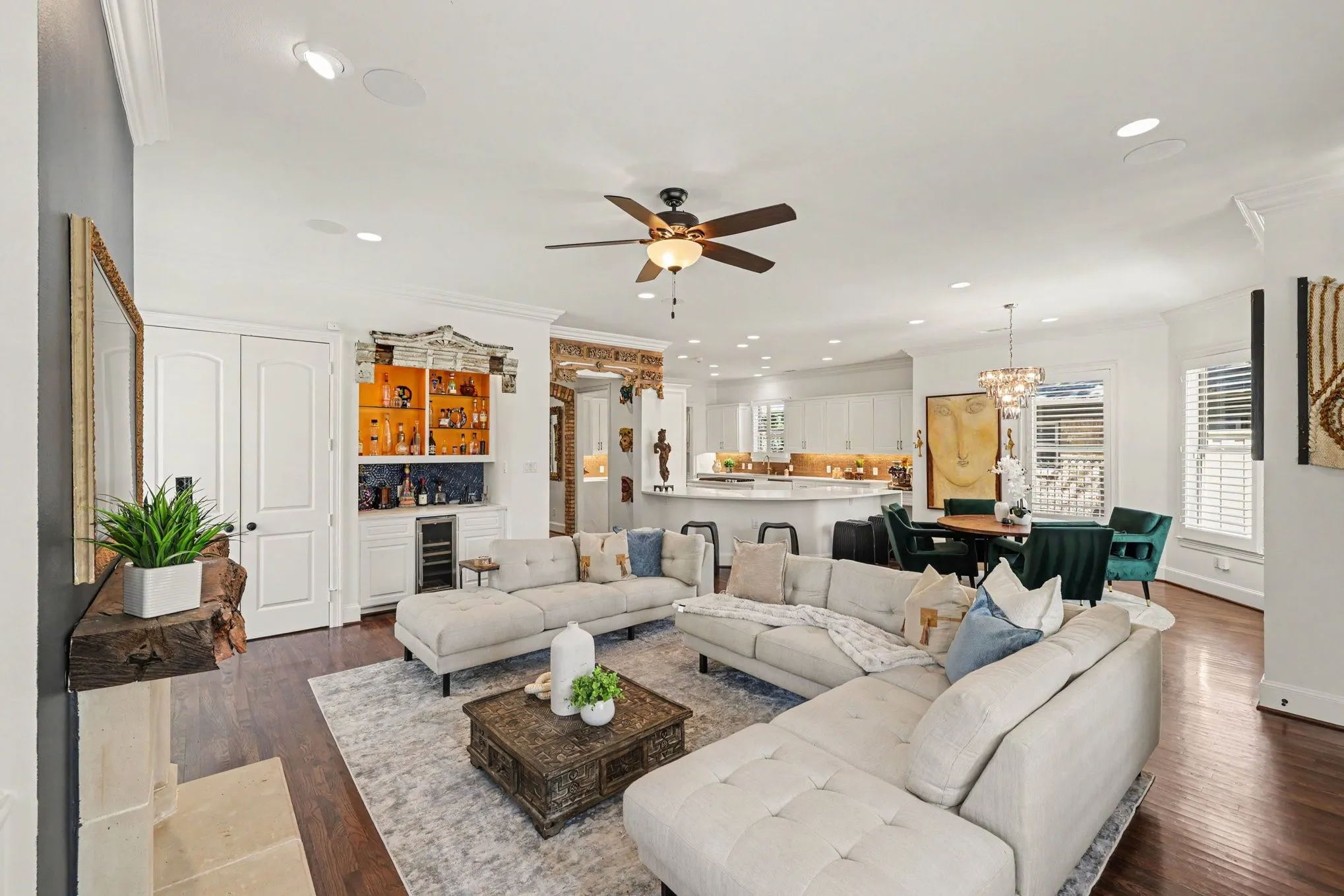 Open-concept living space featuring wood-finish flooring, recessed lighting, and a ceiling fan